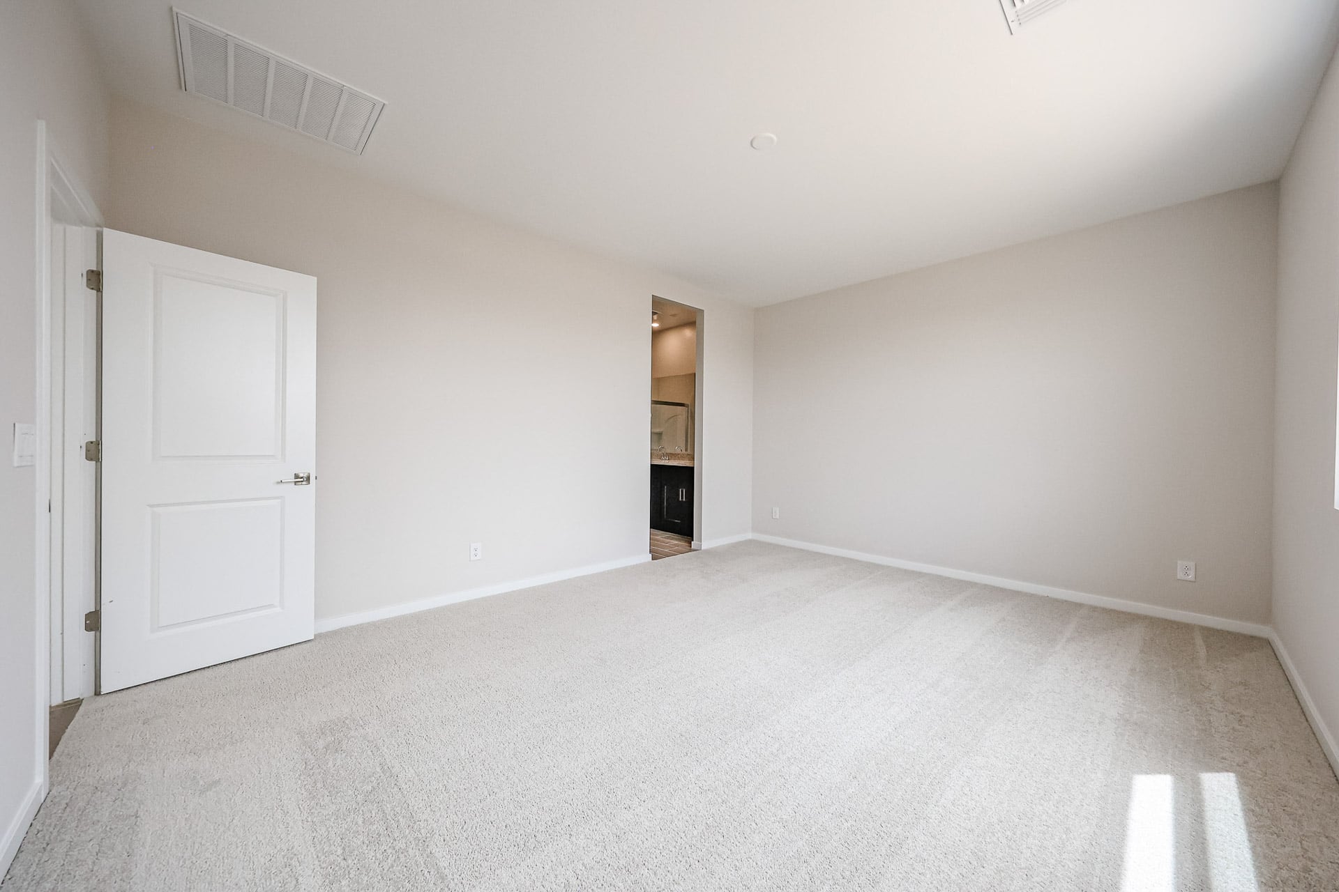A hallway with white walls.
