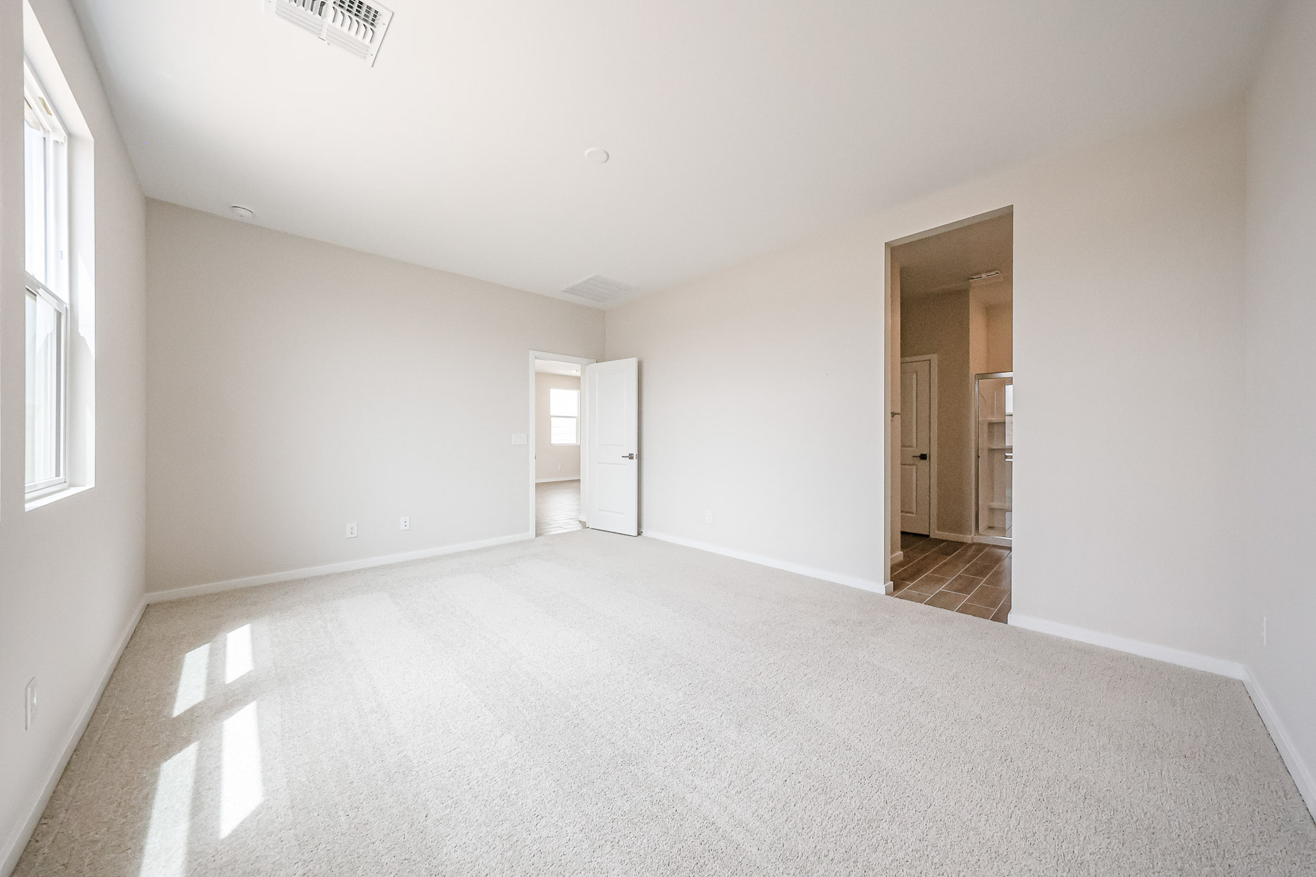 A hallway with white walls.