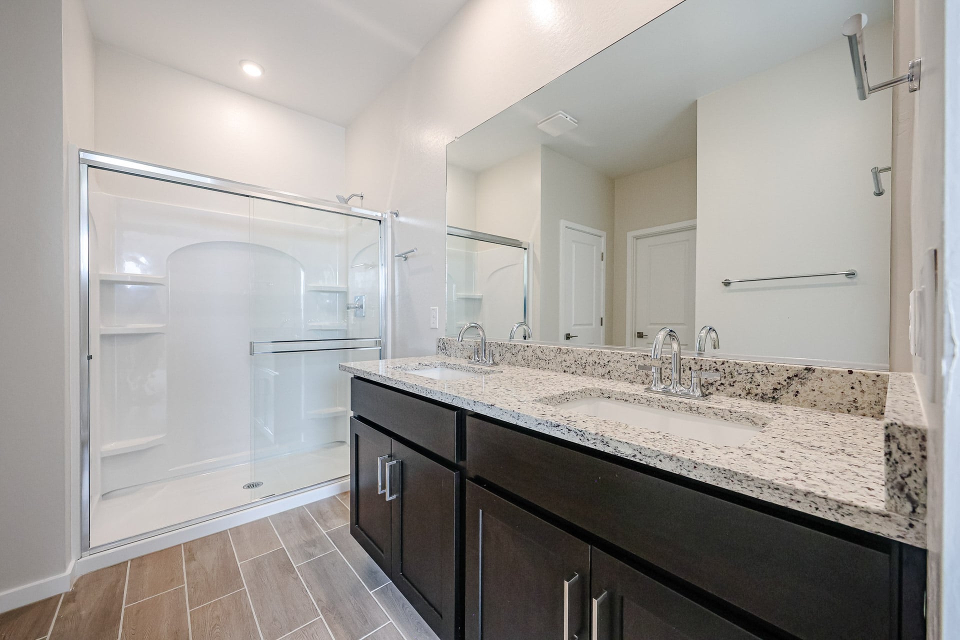 A bathroom with a large mirror.