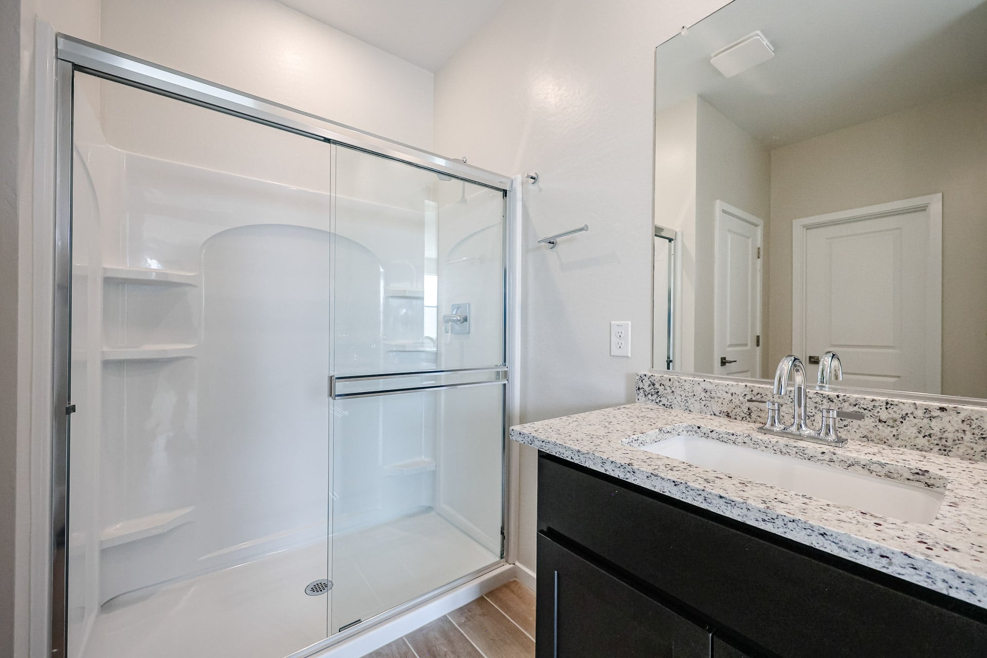 A bathroom with a glass shower.
