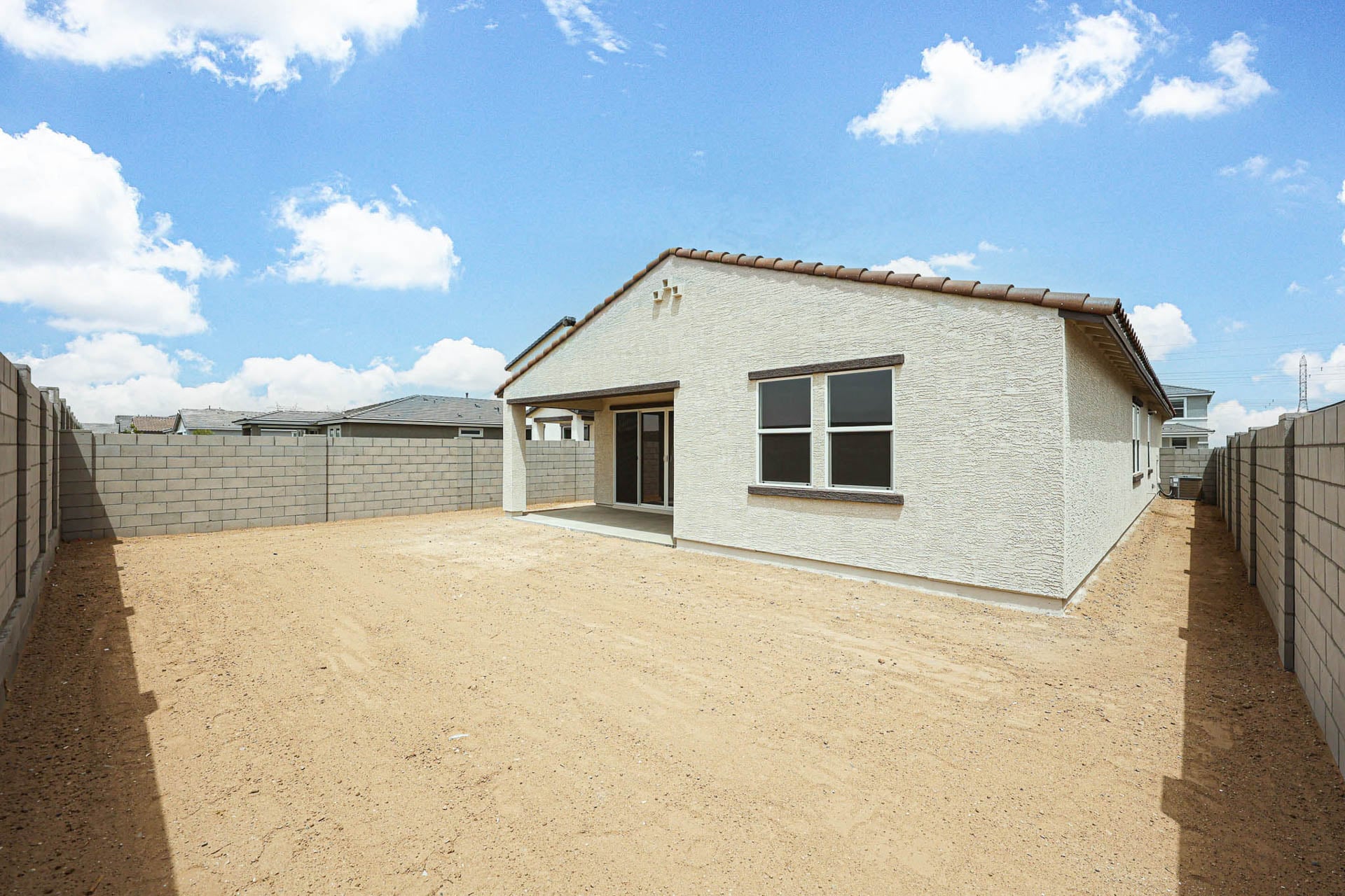 A house in a dirt lot.