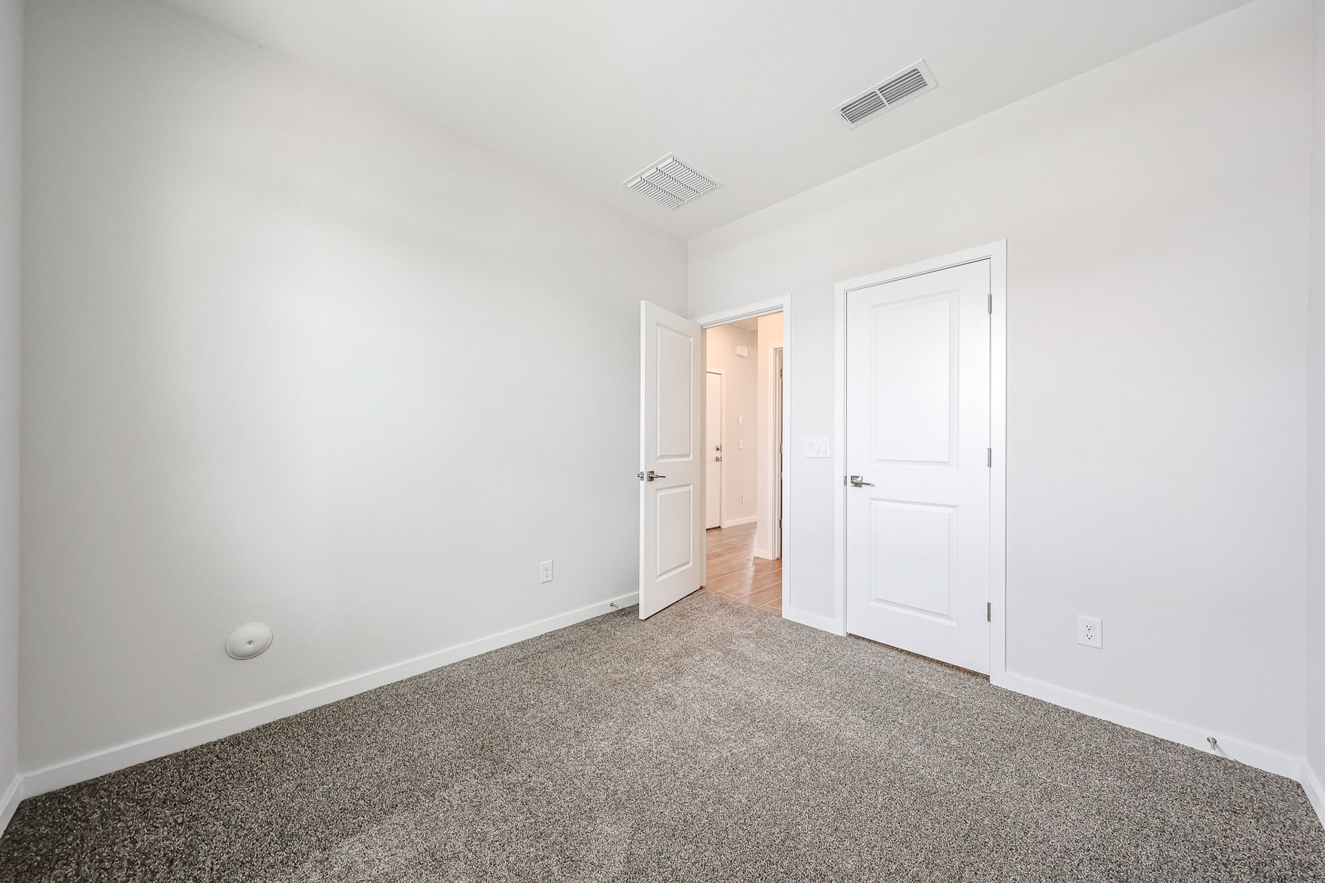 A hallway with white doors.