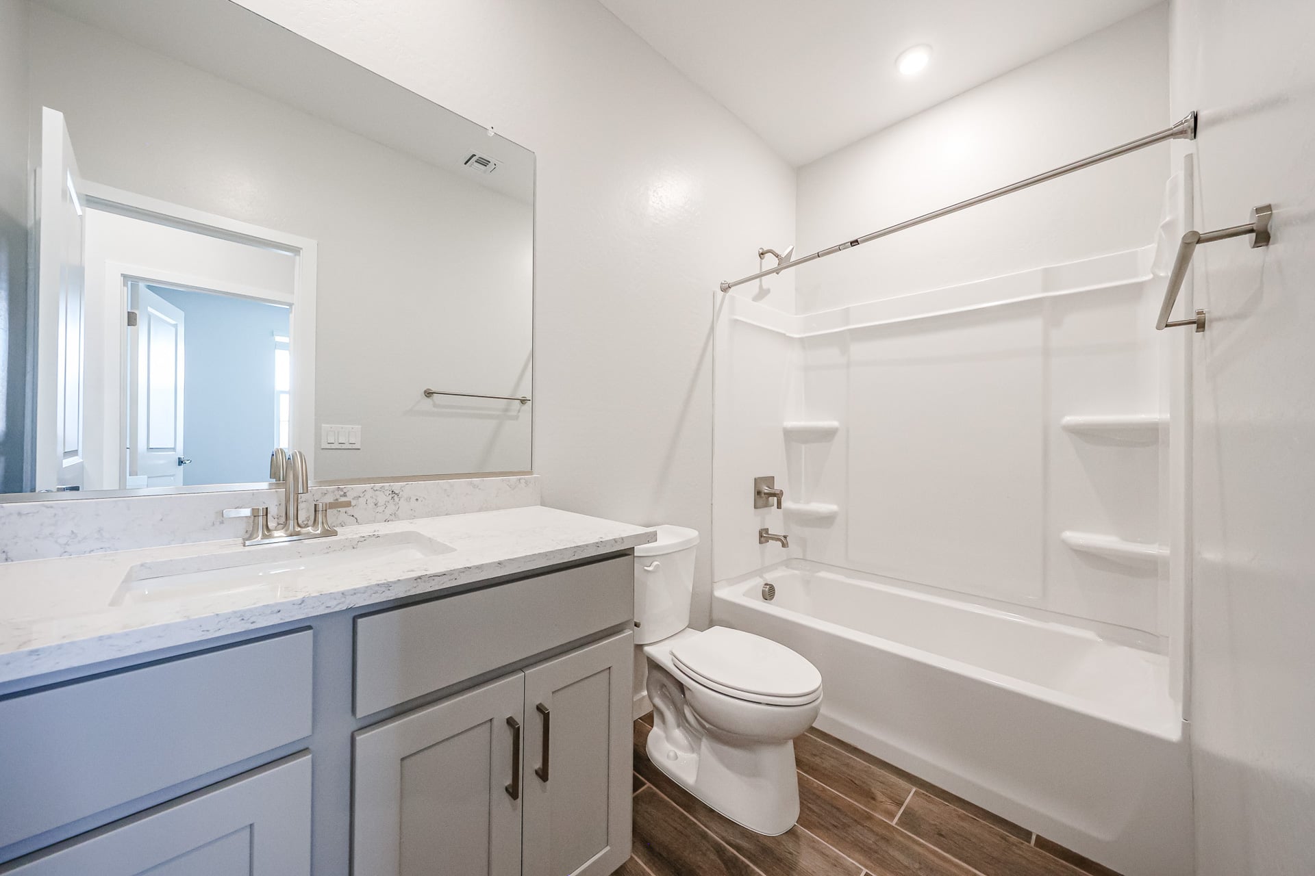 A bathroom with a tub toilet and sink.