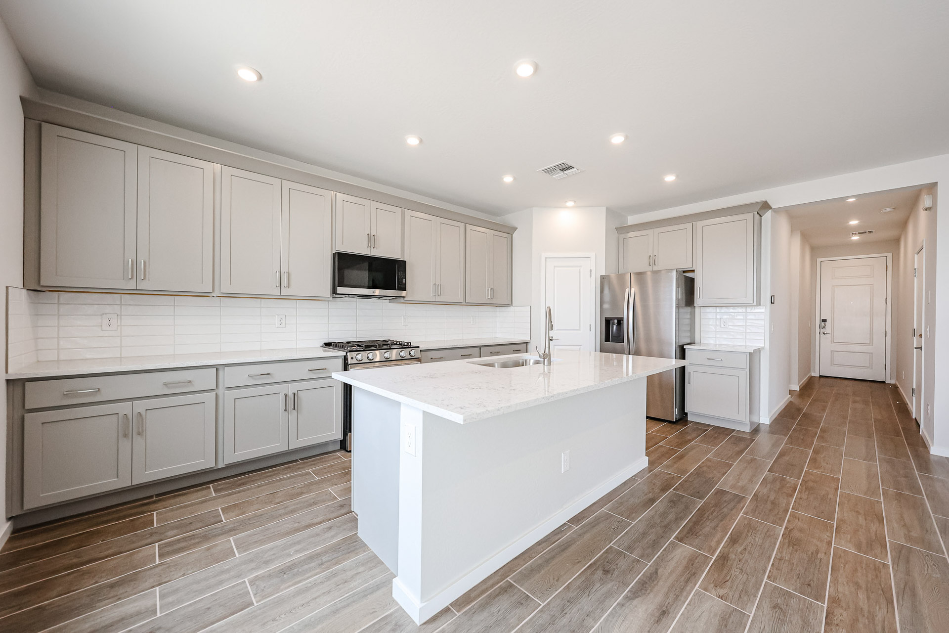 A kitchen with white cabinets.