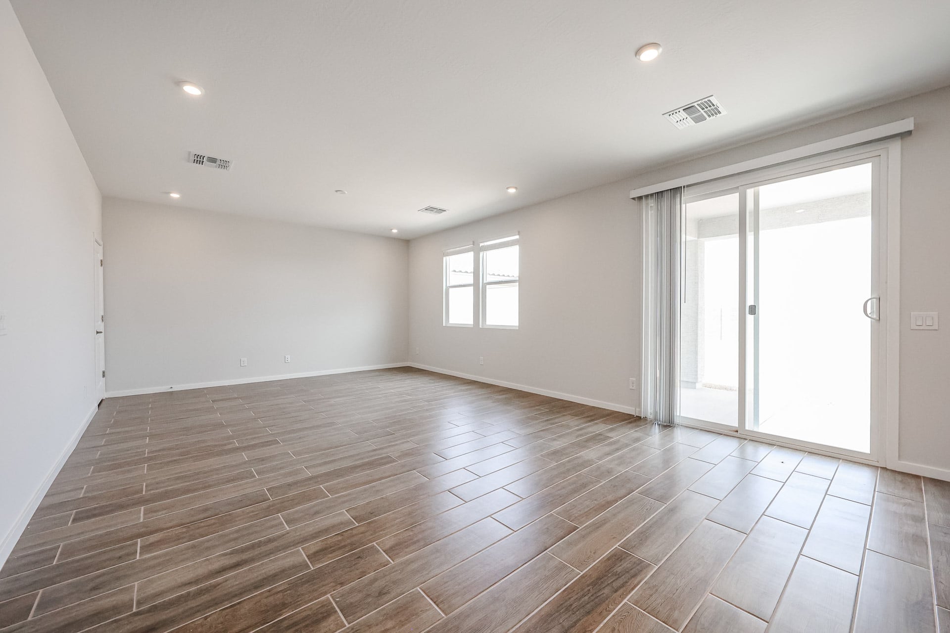 A room with a wood floor and white walls.