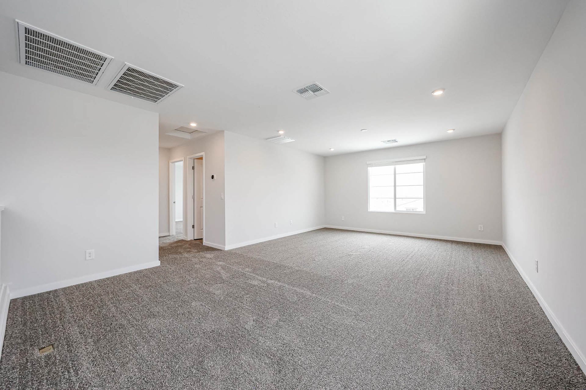 A room with a carpet and a carpet.