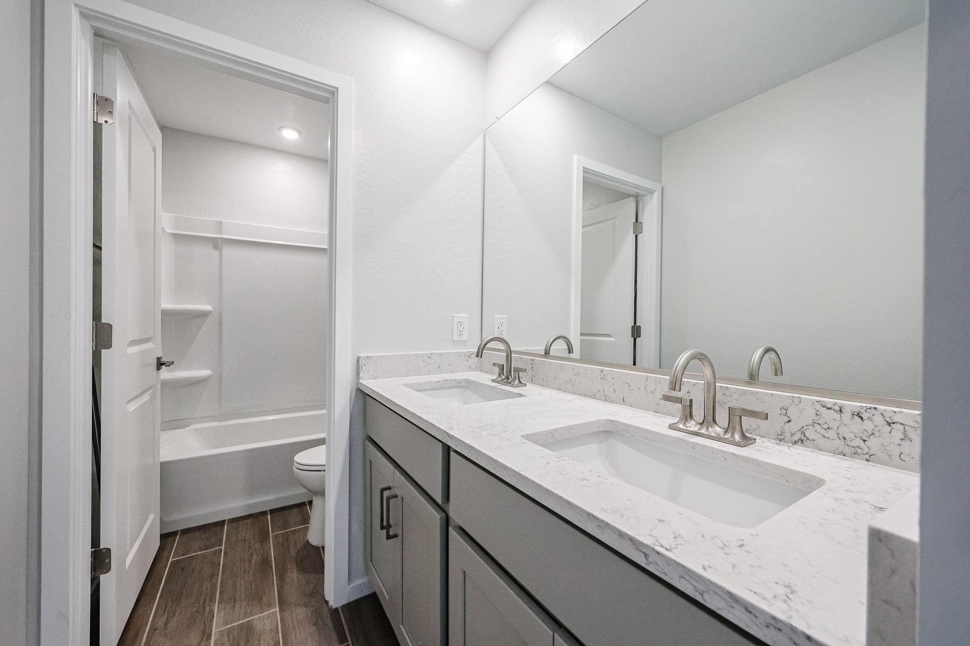 A bathroom with a sink and a shower.