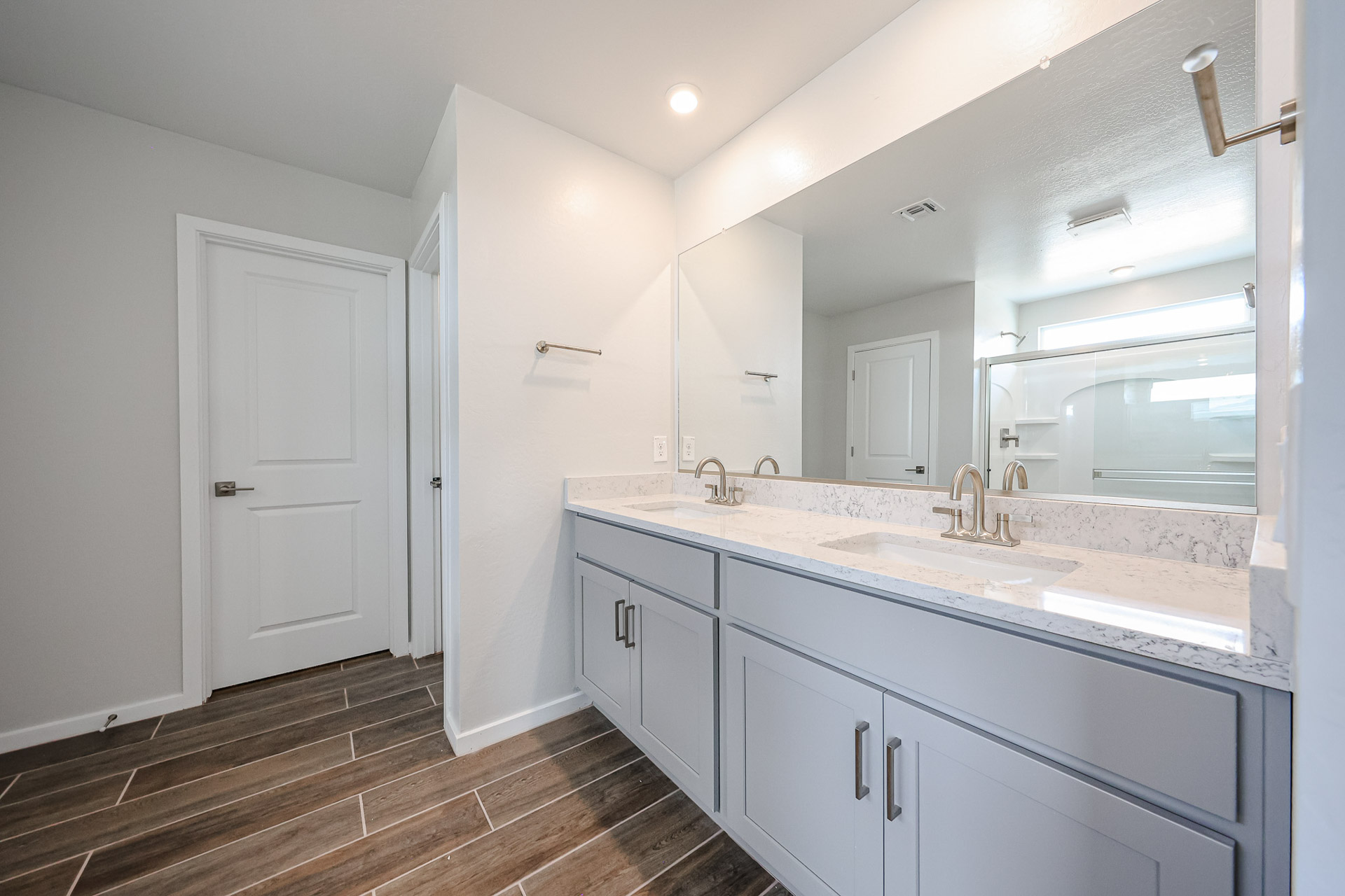 A bathroom with white cabinets.