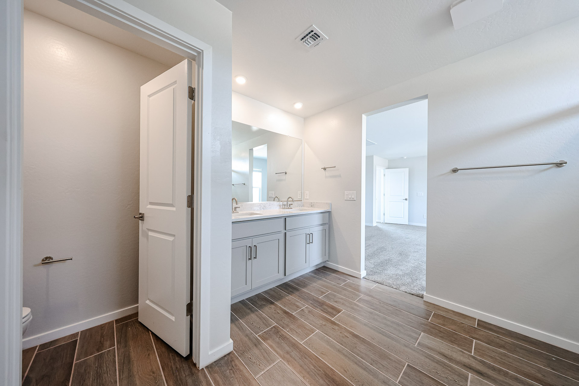 A bathroom with white cabinets.