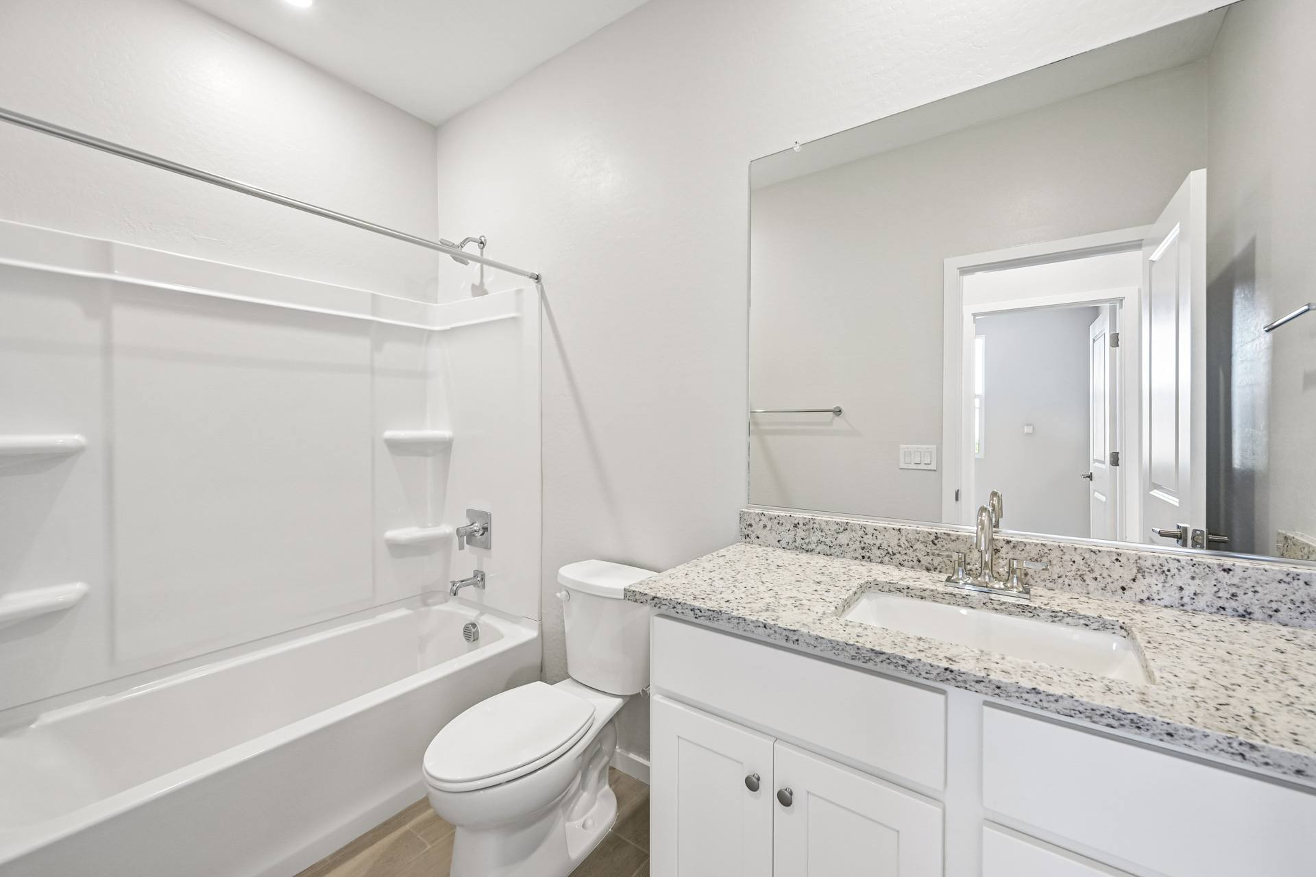 A bathroom with a tub sink and toilet.
