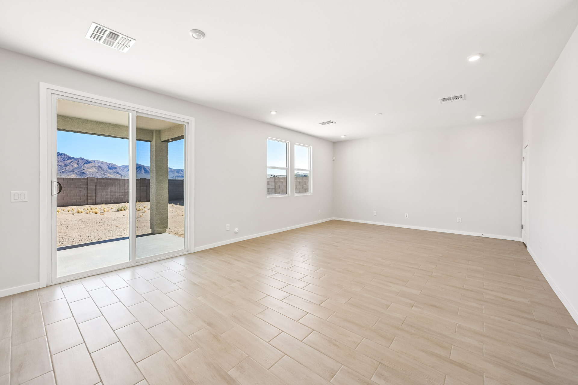 A room with a wood floor and a glass door.