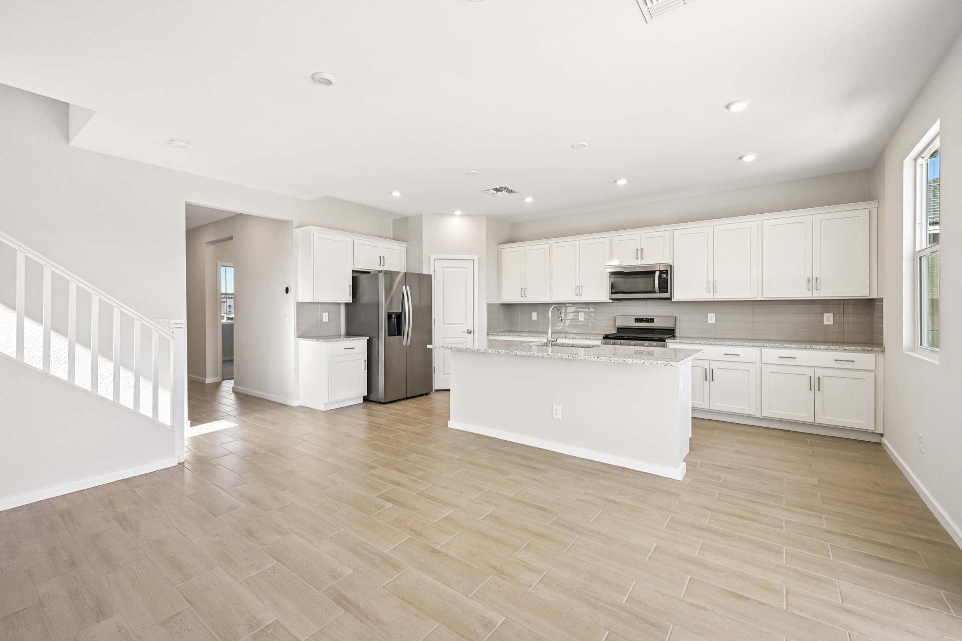 A large kitchen with white cabinets.