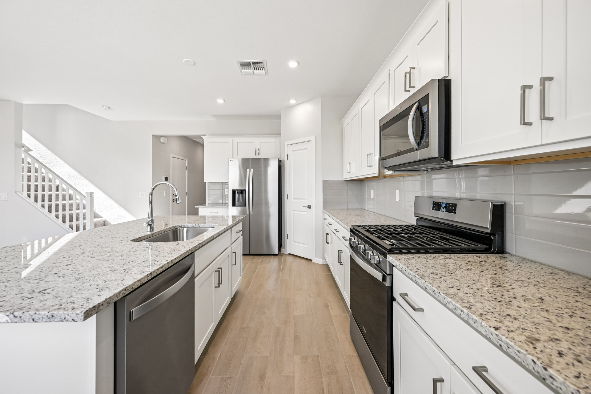 A kitchen with white cabinets.