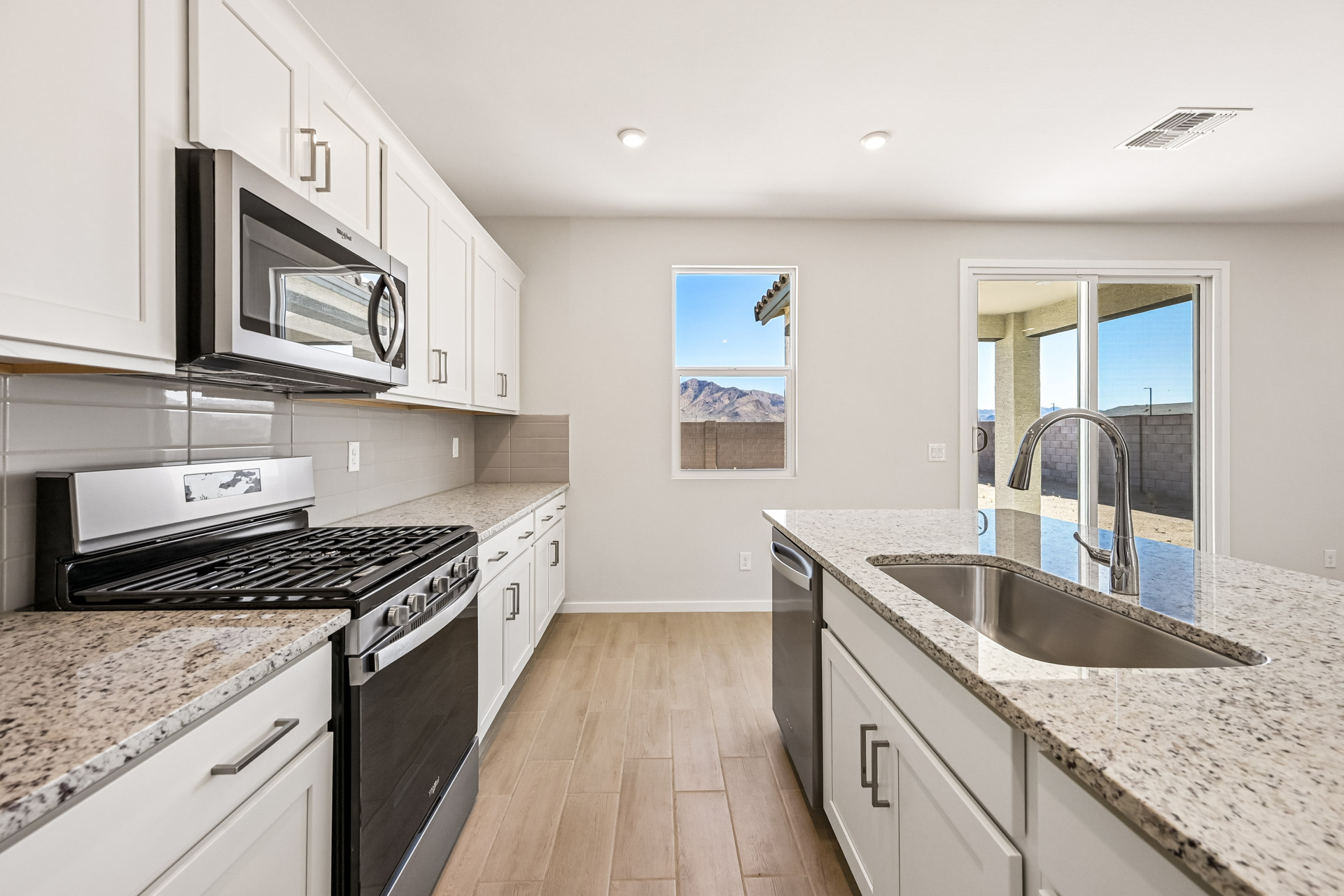 A kitchen with white cabinets.