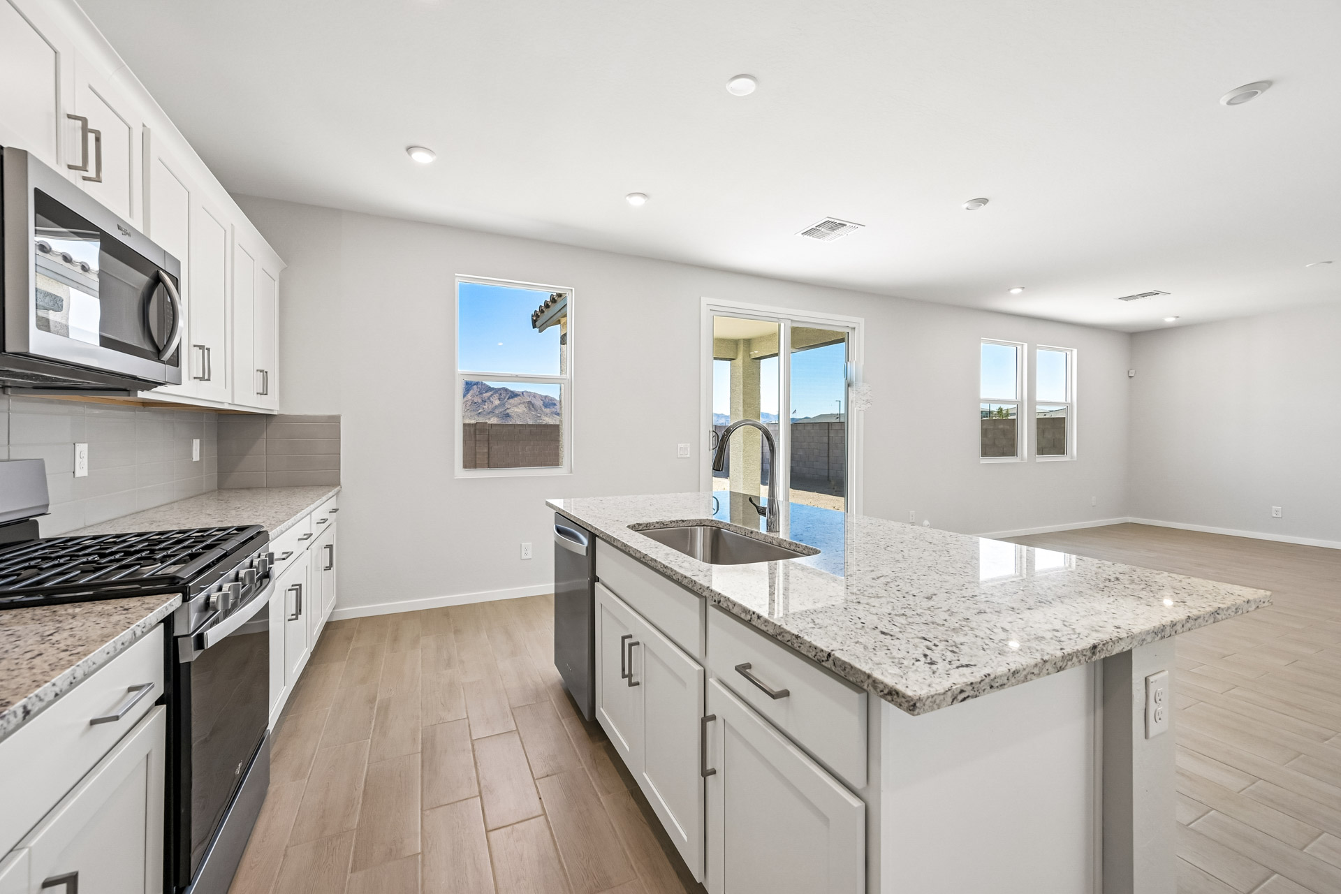 A kitchen with white cabinets.