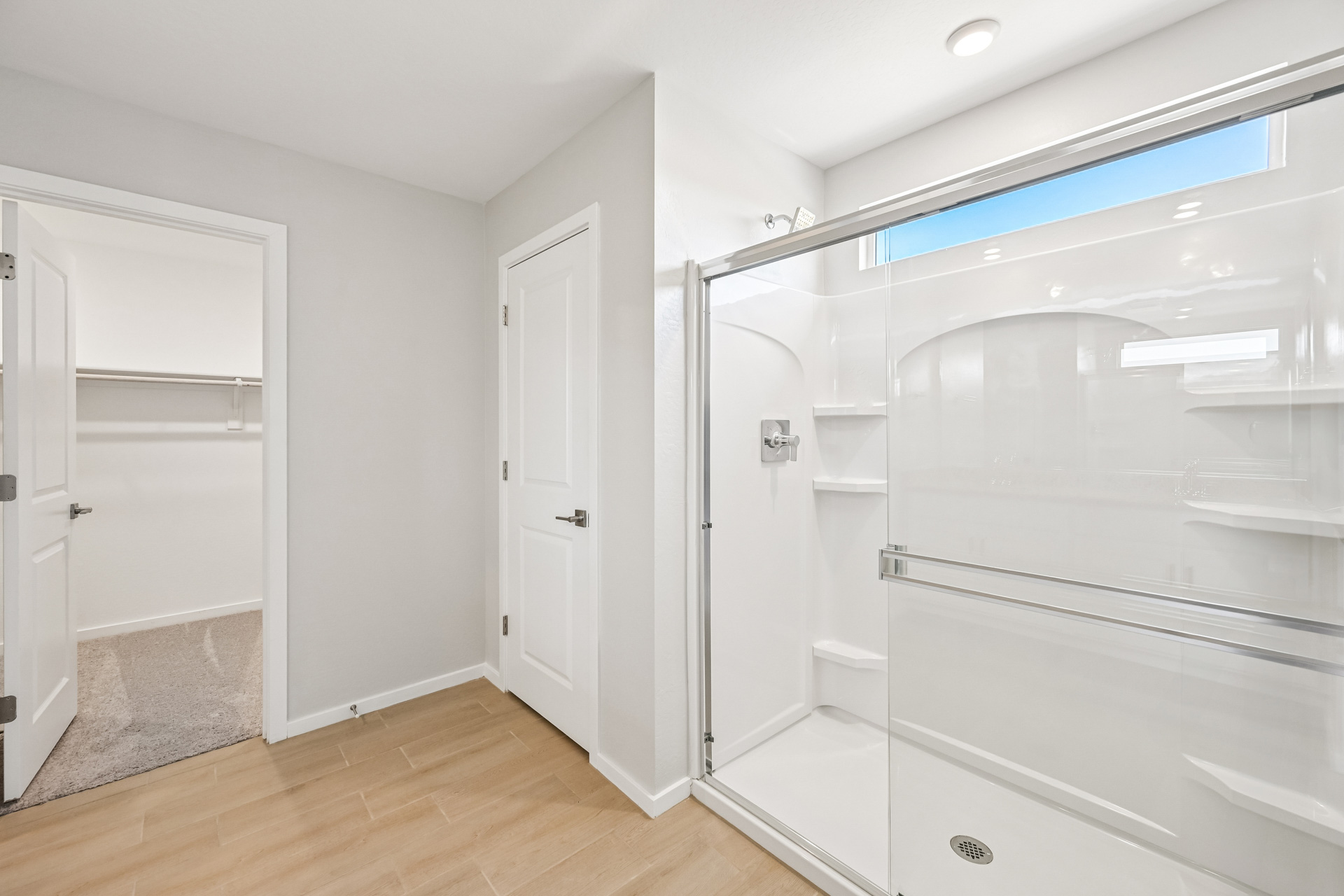 A bathroom with white cabinets.