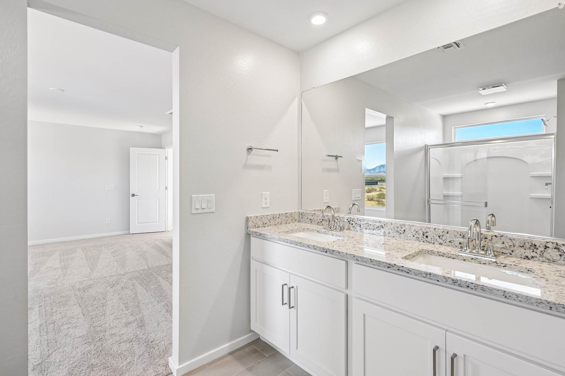 A bathroom with a marble countertop.
