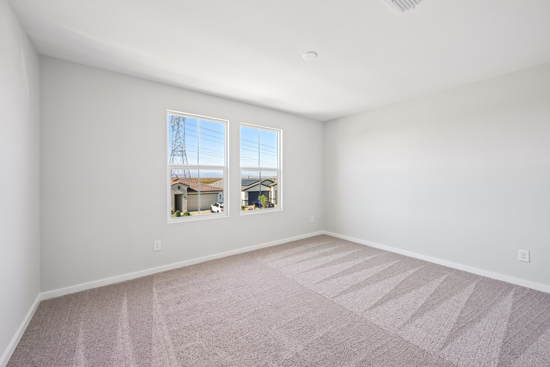 A room with a window and a carpet.