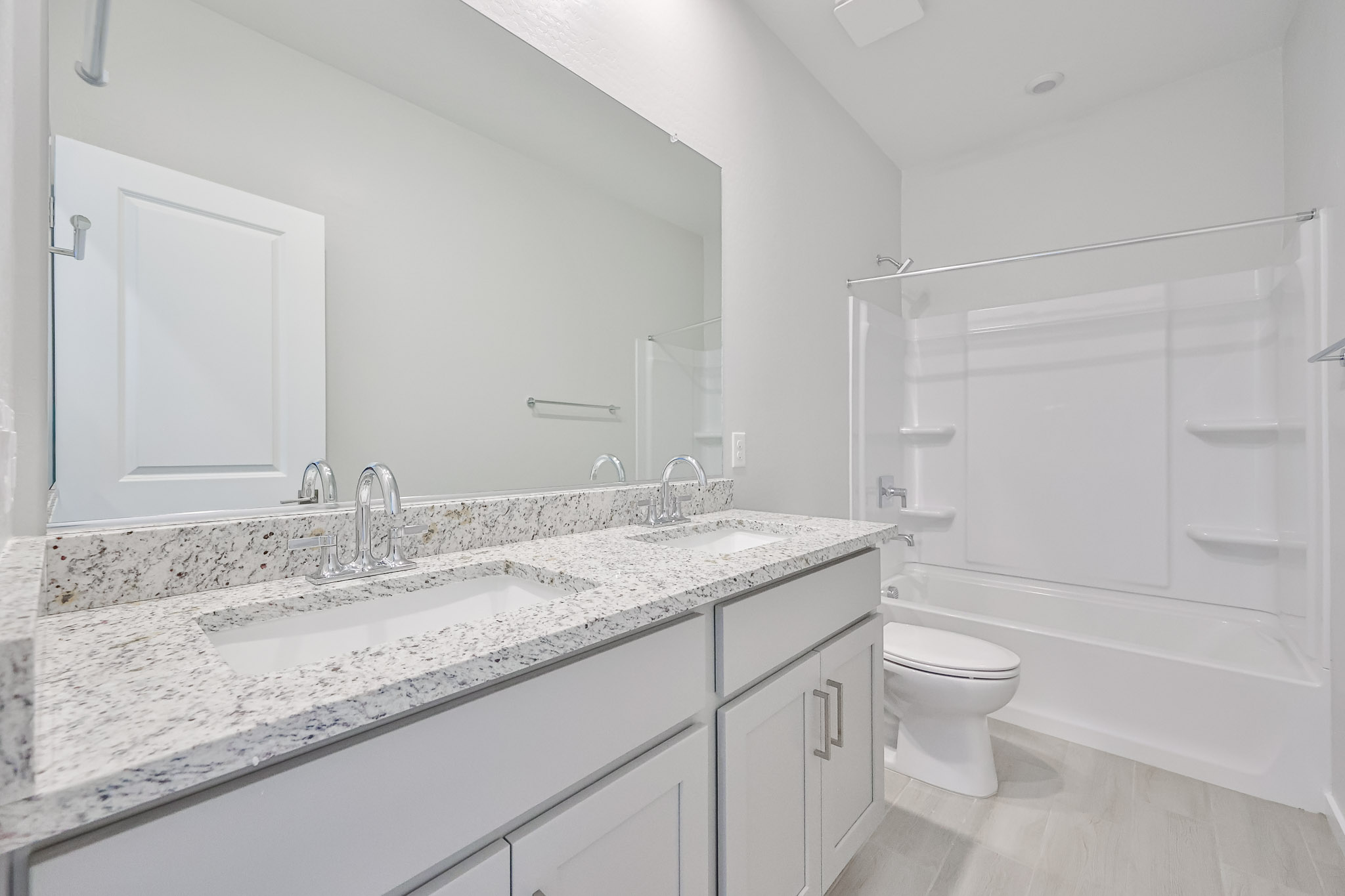 A bathroom with a sink toilet and shower.