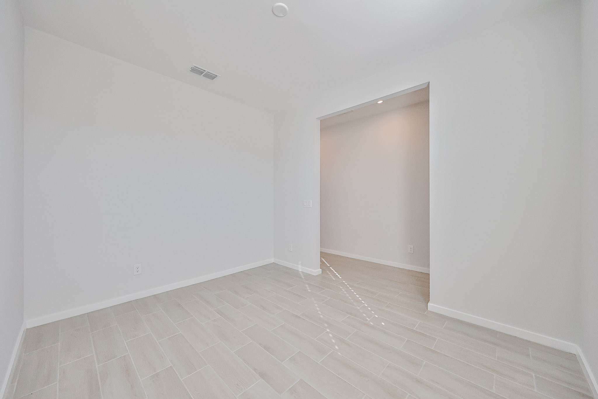 A hallway with white walls.