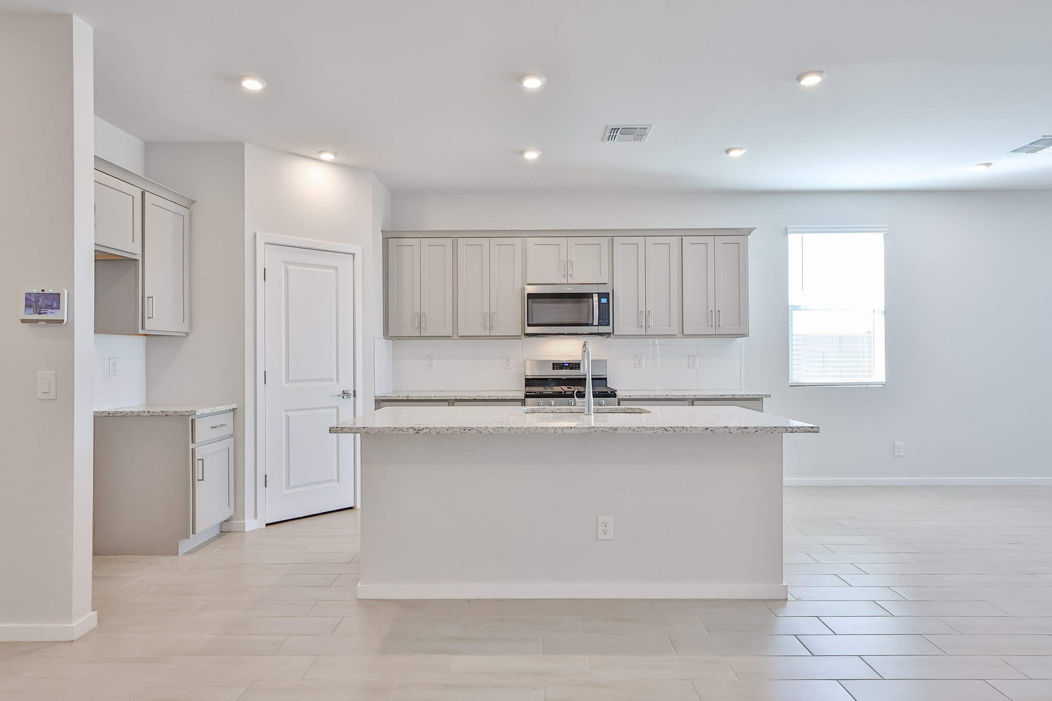 A kitchen with white cabinets.