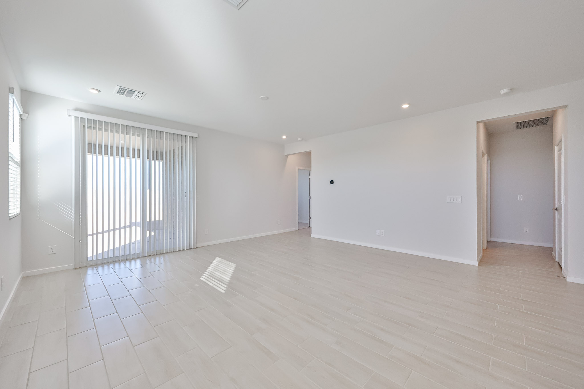 A room with white walls and a wood floor.