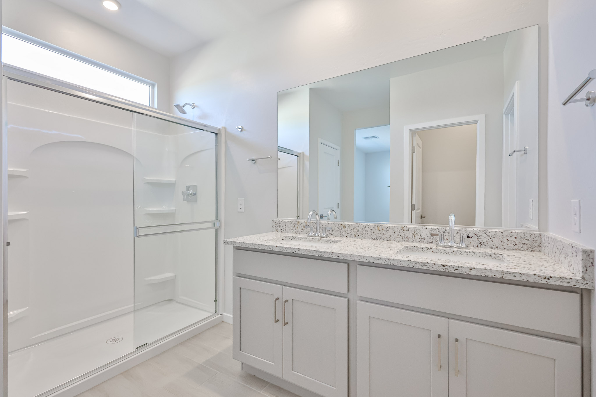 A bathroom with a large mirror.