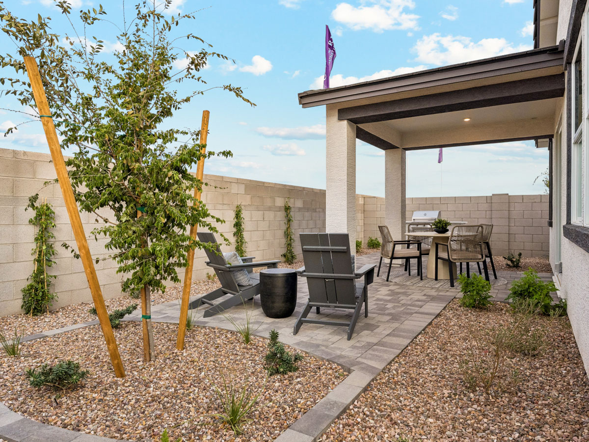 A patio with a table and chairs.