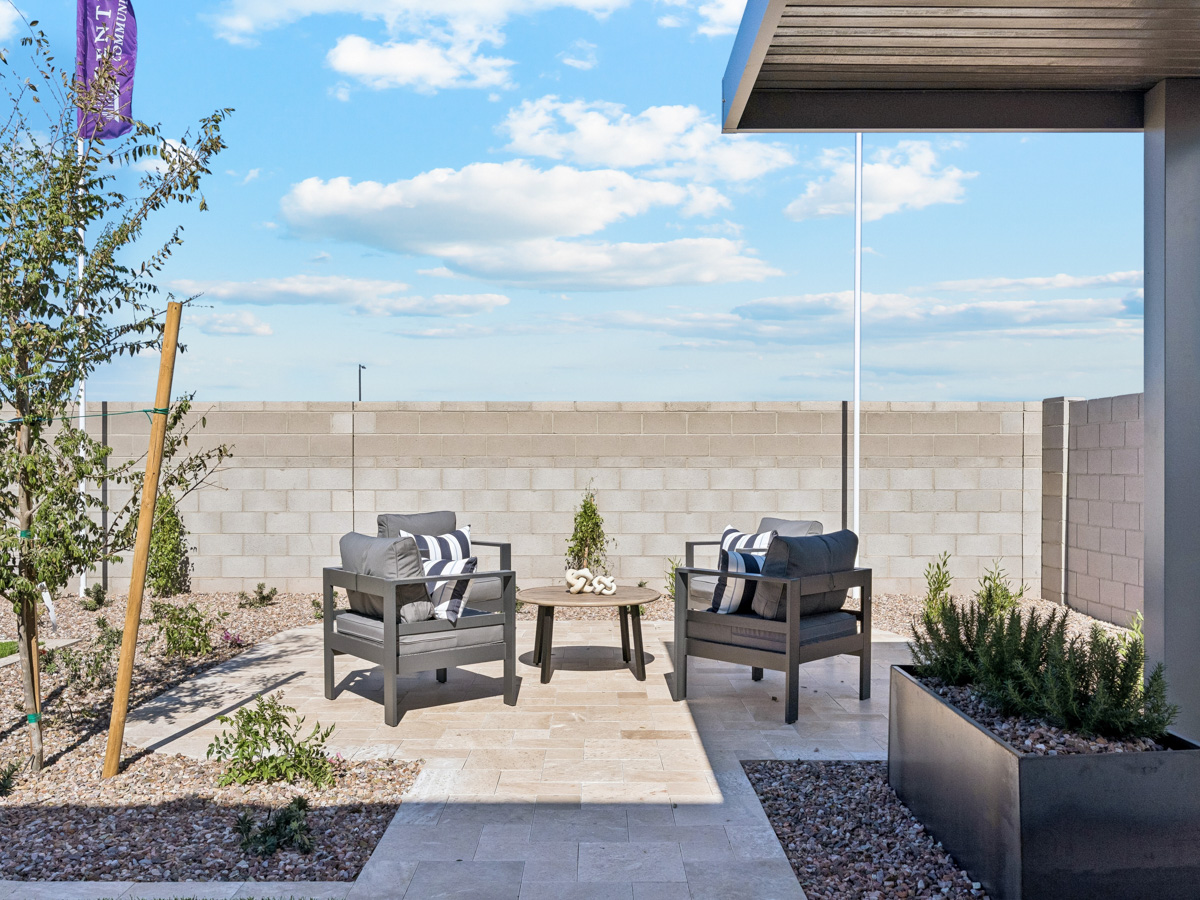 A patio with a table and chairs.