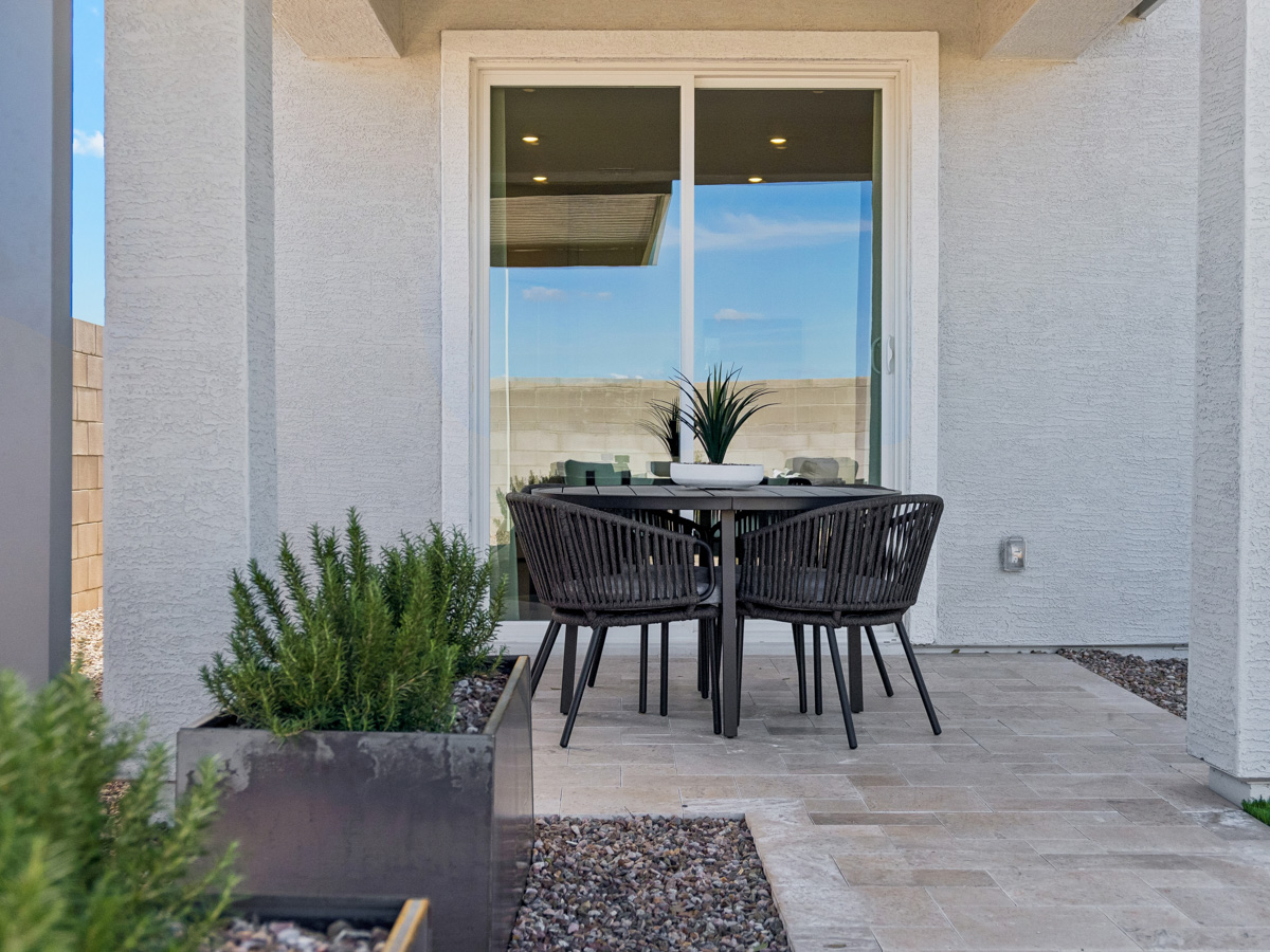 A table and chairs on a patio.