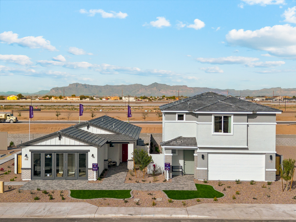 A few buildings with a hill in the background.