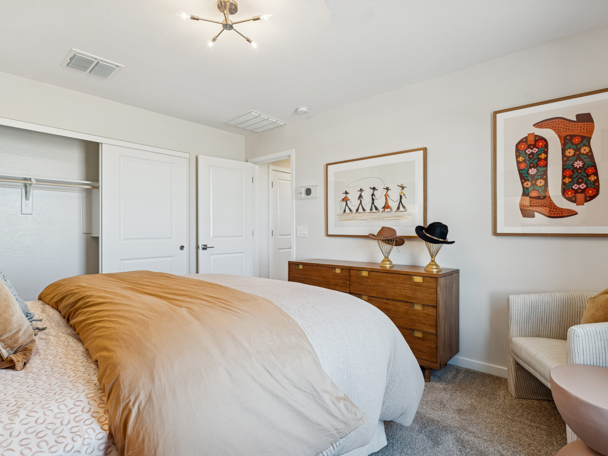 A bedroom with a bed and a table.