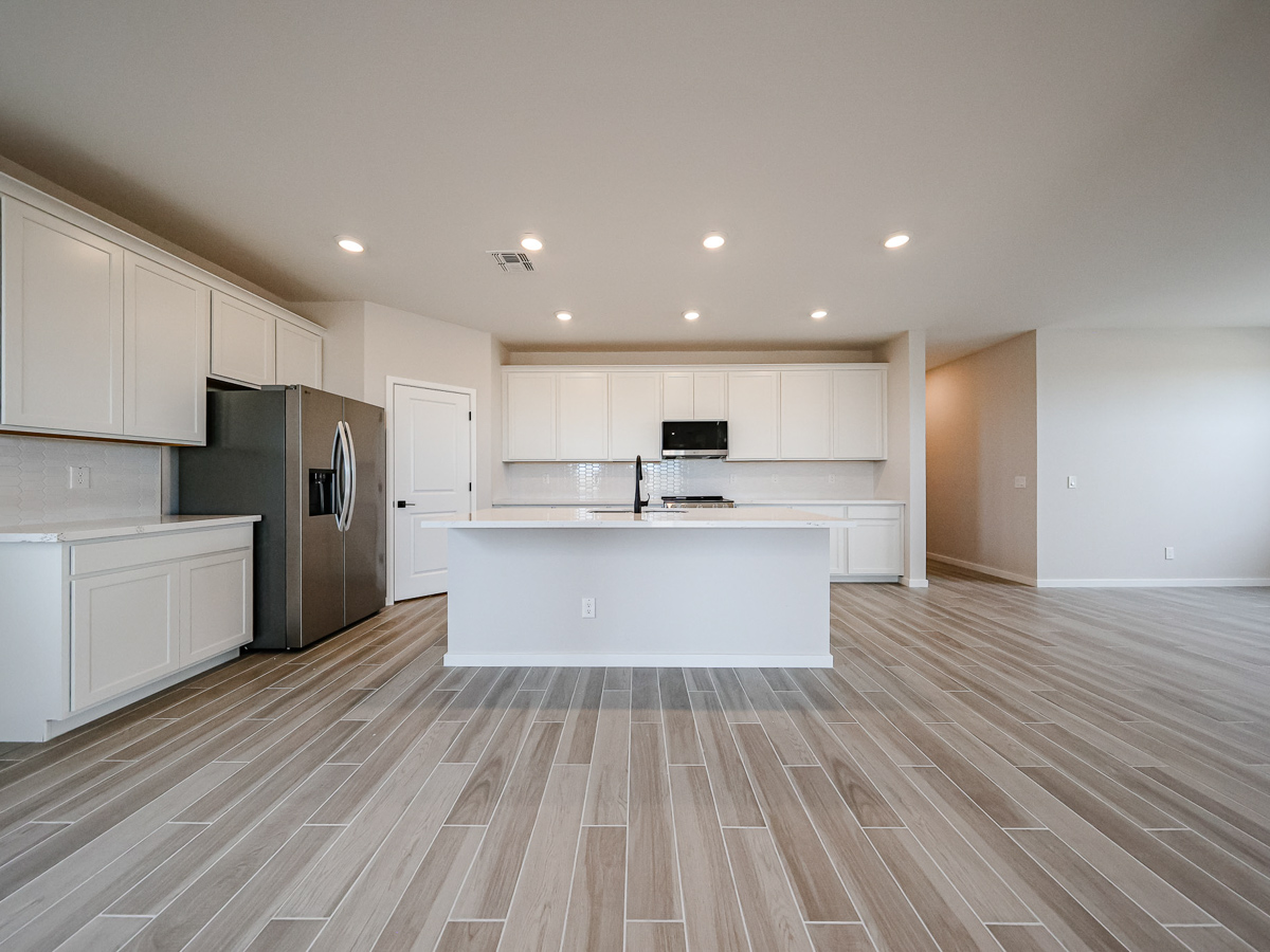 A kitchen with white cabinets.