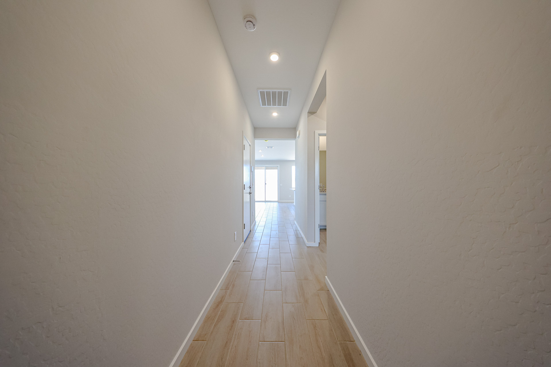 A long hallway with white walls.