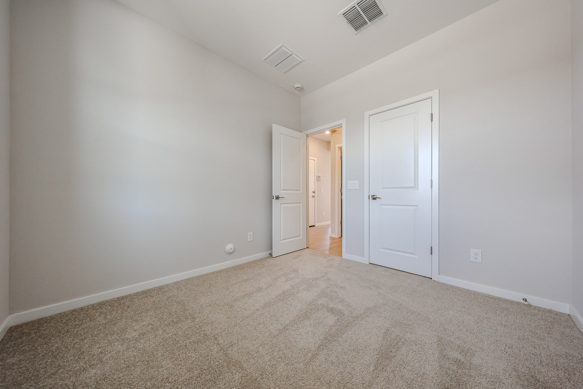 A hallway with white doors.