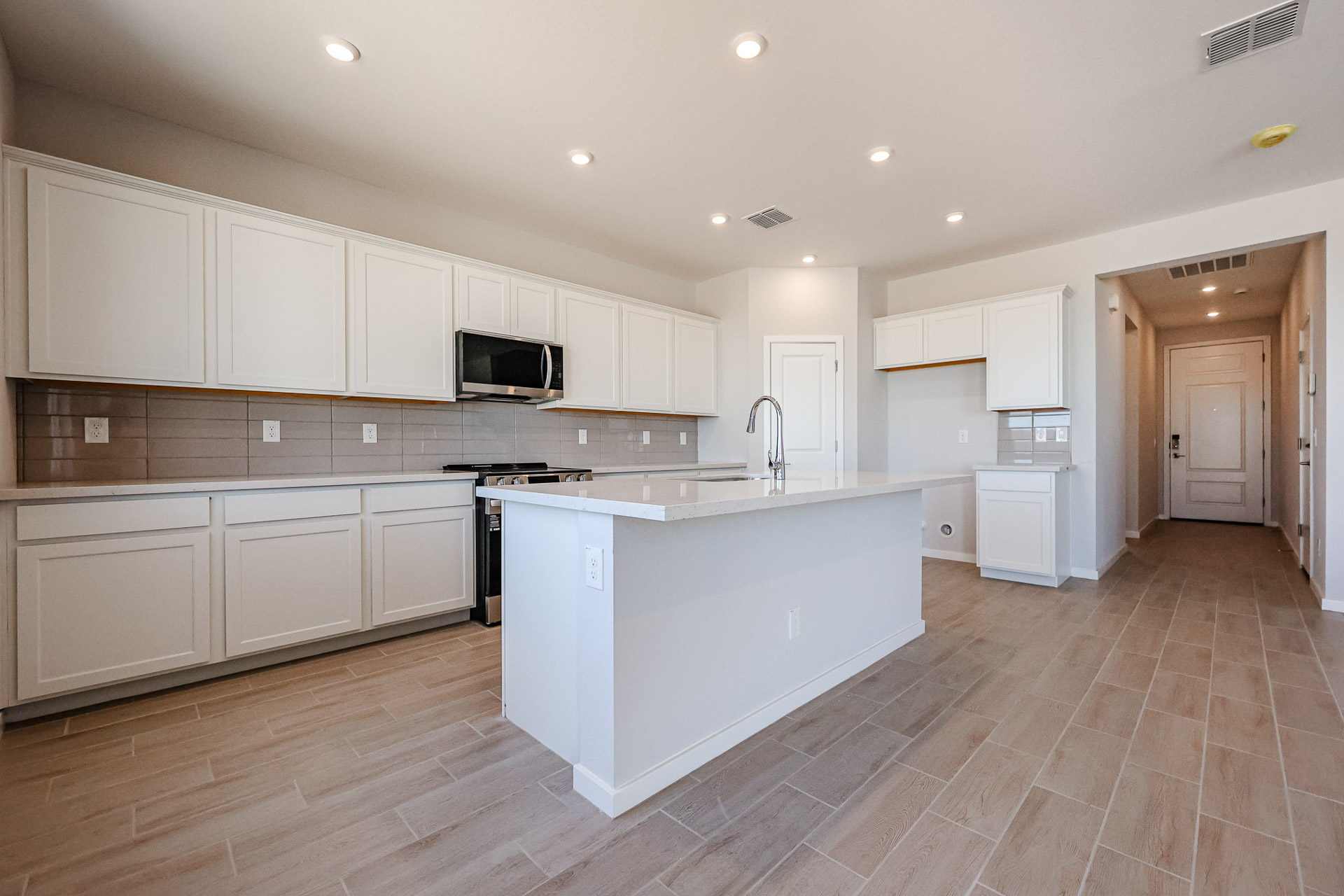 A kitchen with white cabinets.