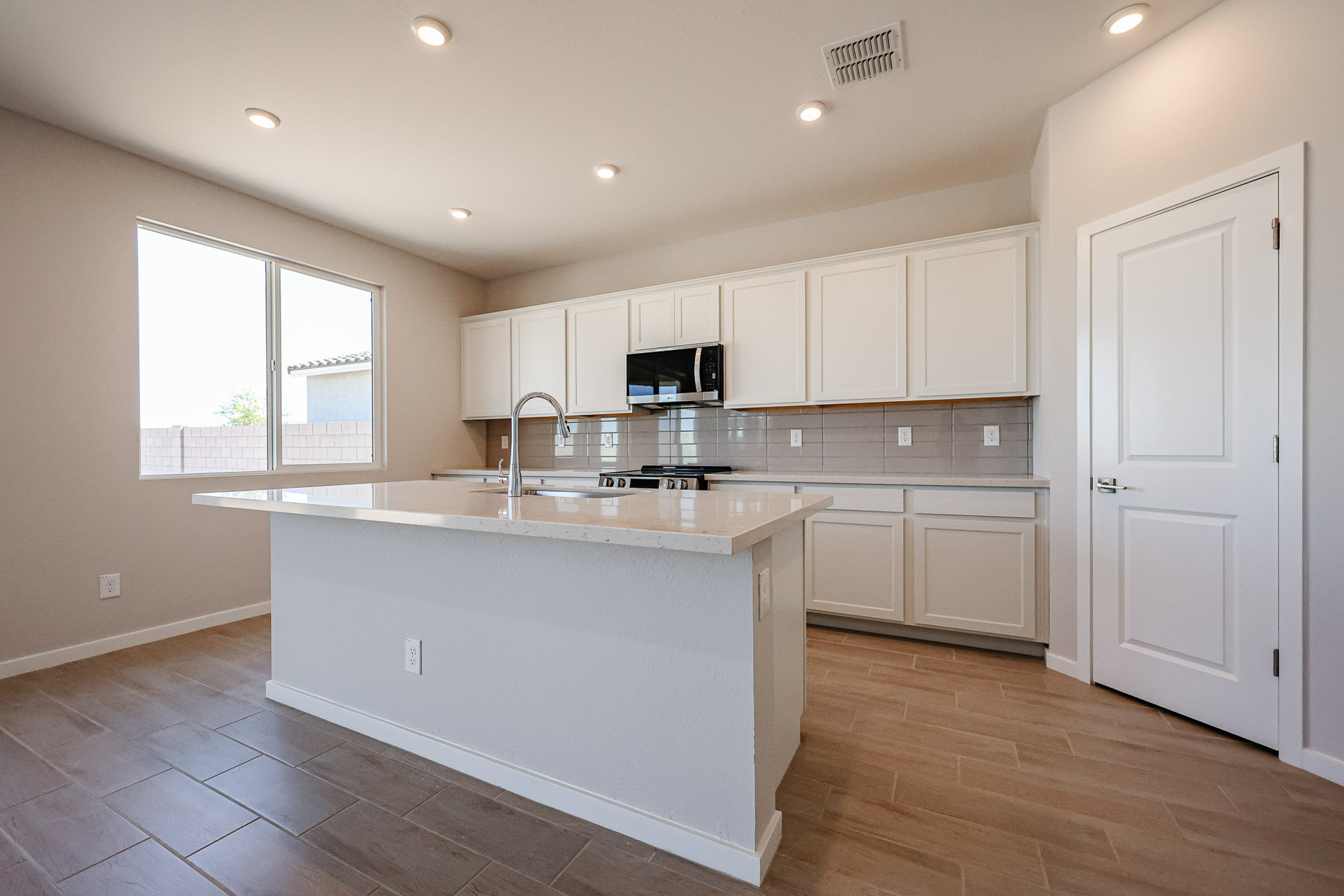 A kitchen with white cabinets.