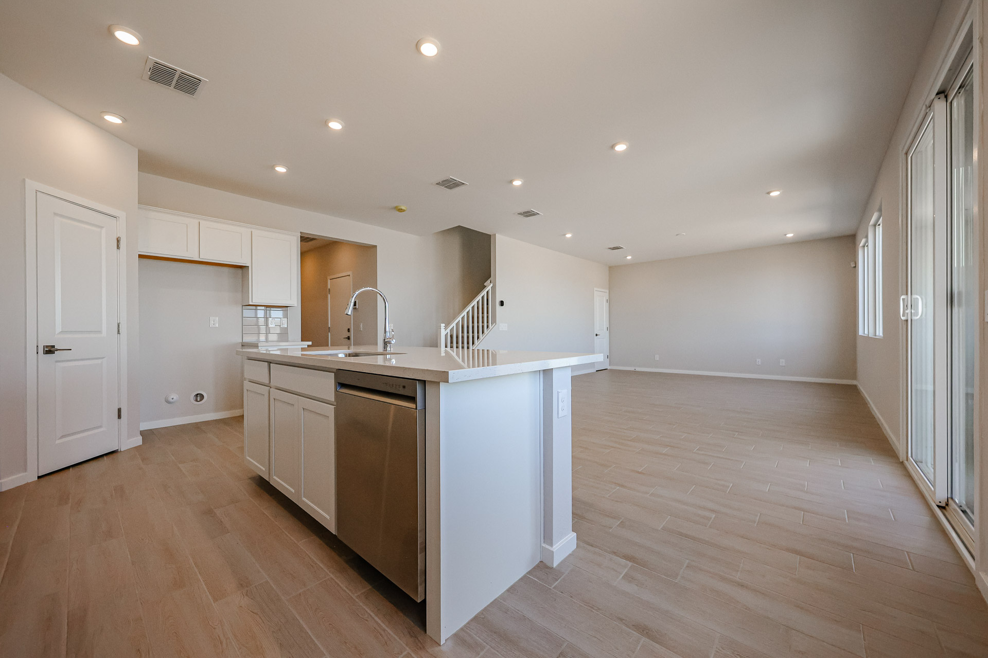 A kitchen with white cabinets.