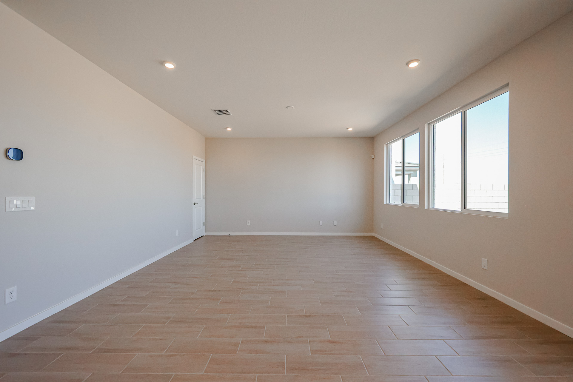 A room with windows and a tile floor.