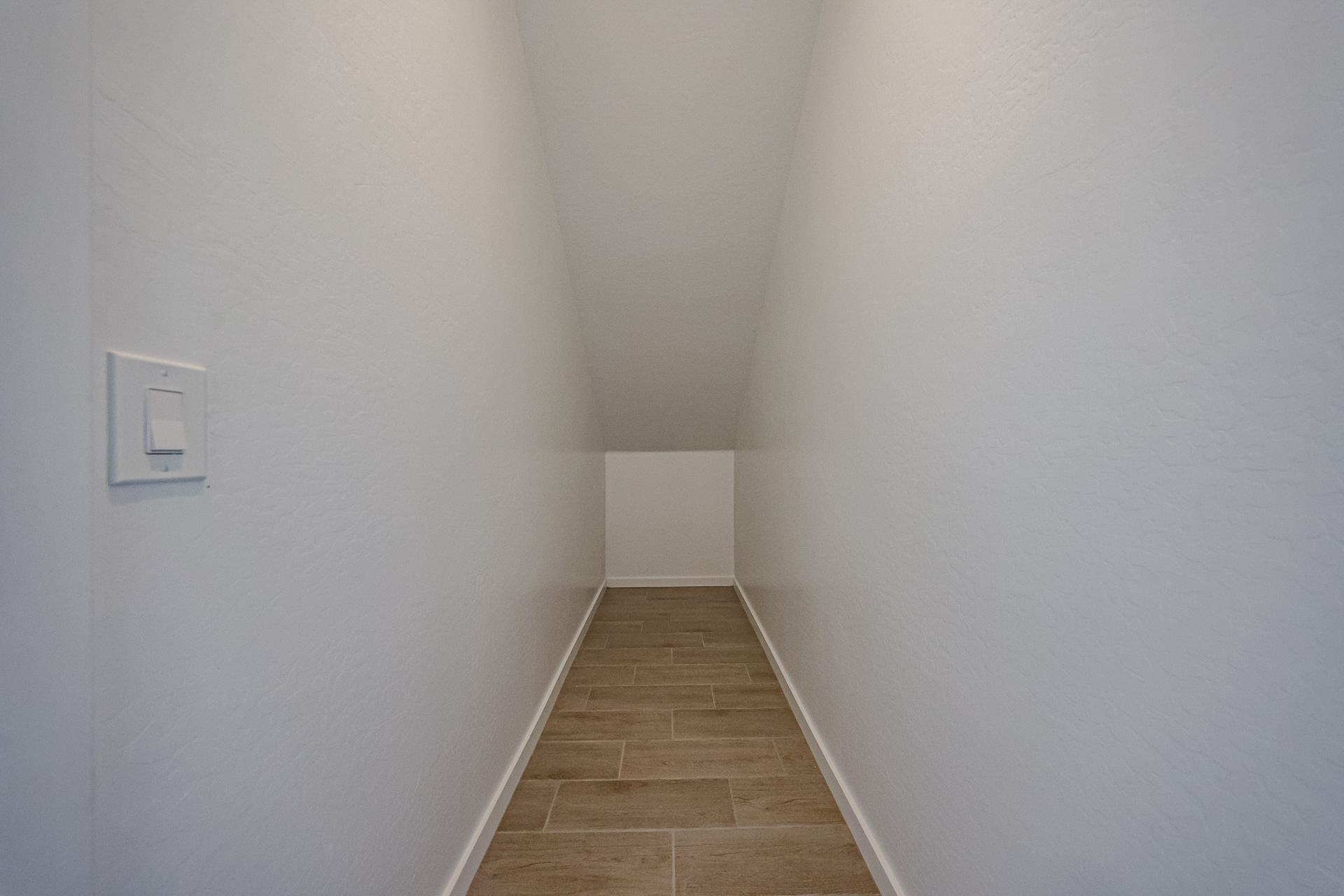 A hallway with white walls.