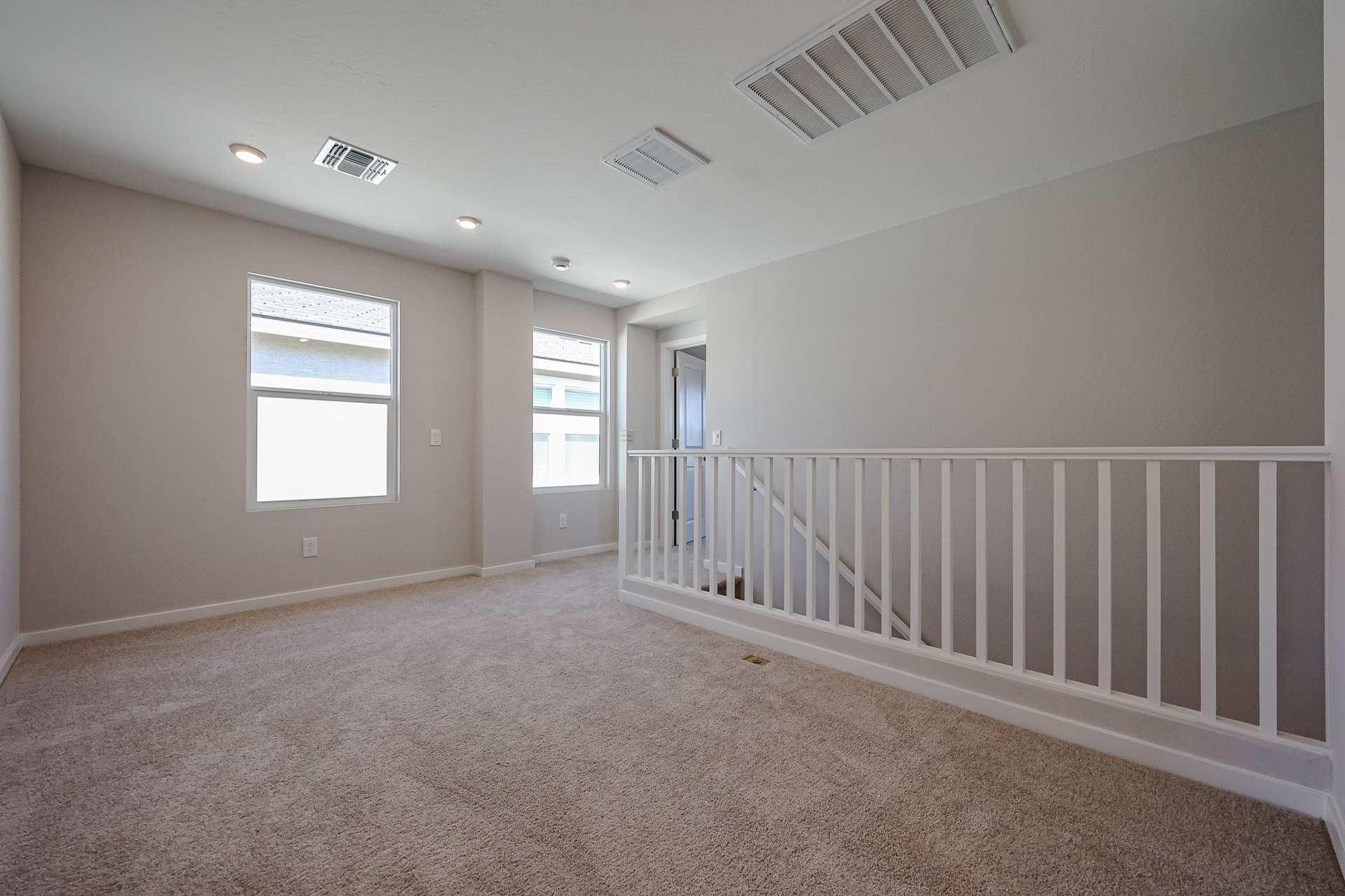 A room with a white railing and a white railing.