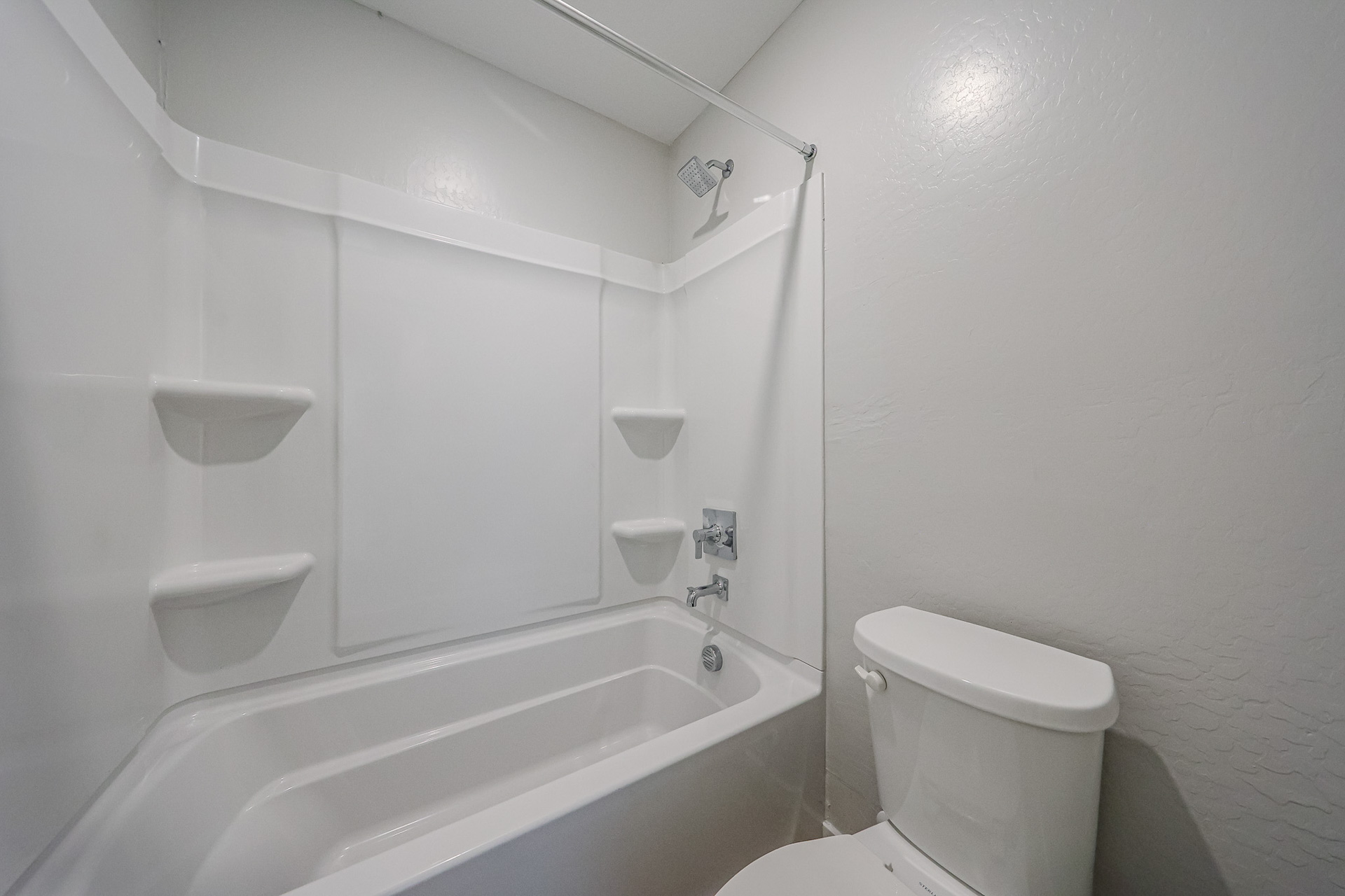 A bathroom with a tub toilet and sink.