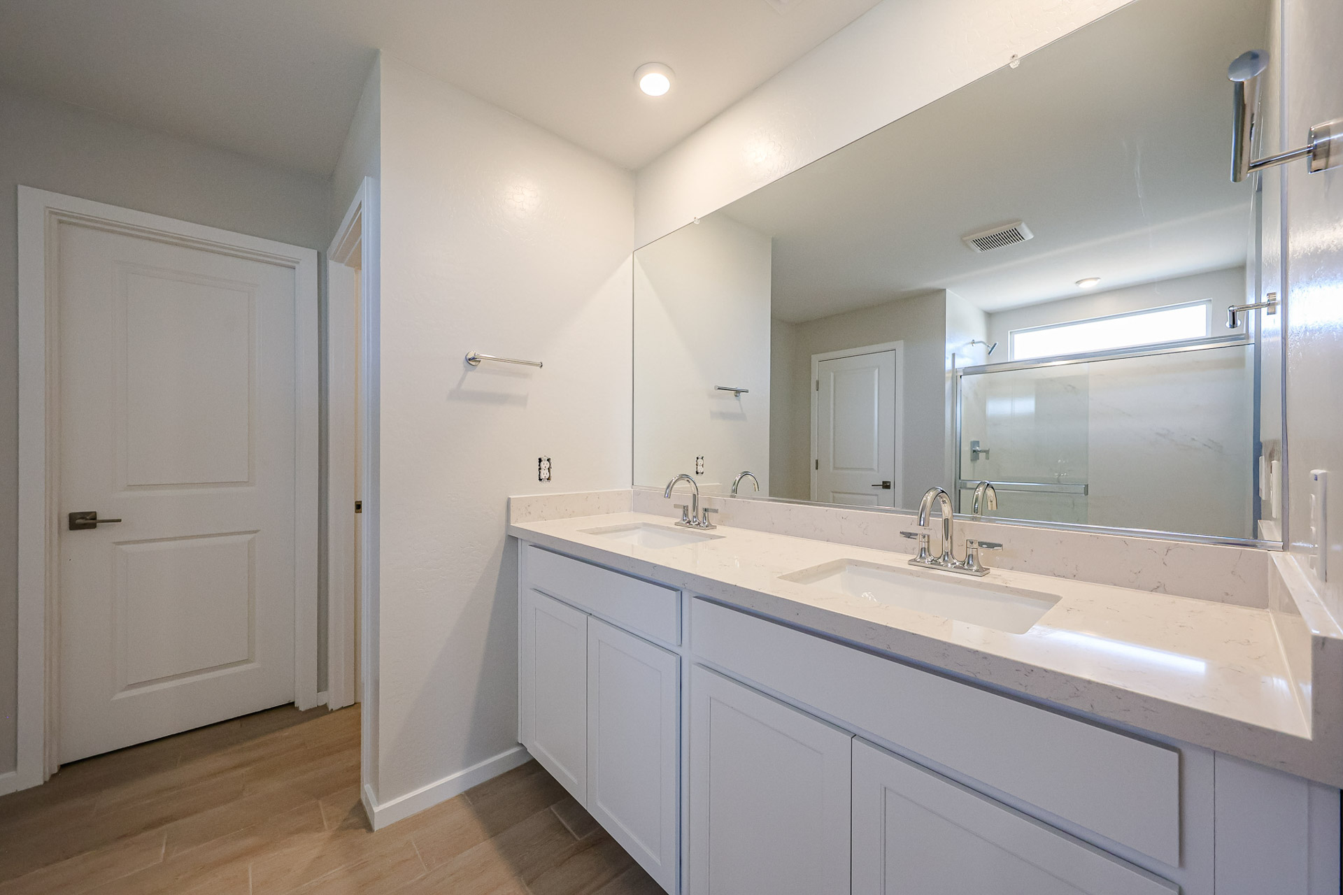 A bathroom with white cabinets.