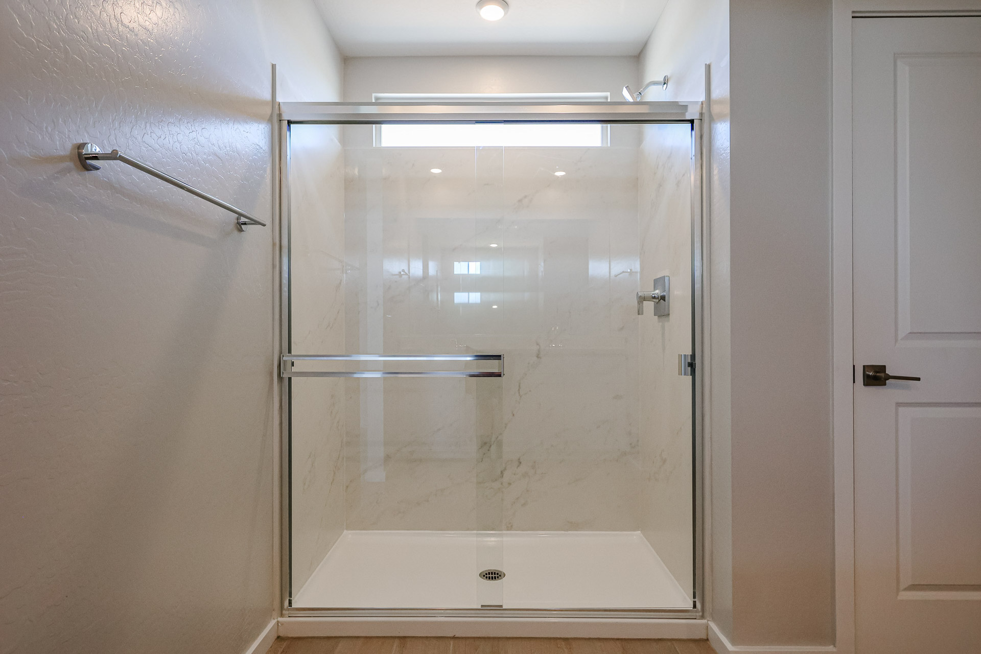 A shower with a glass door.