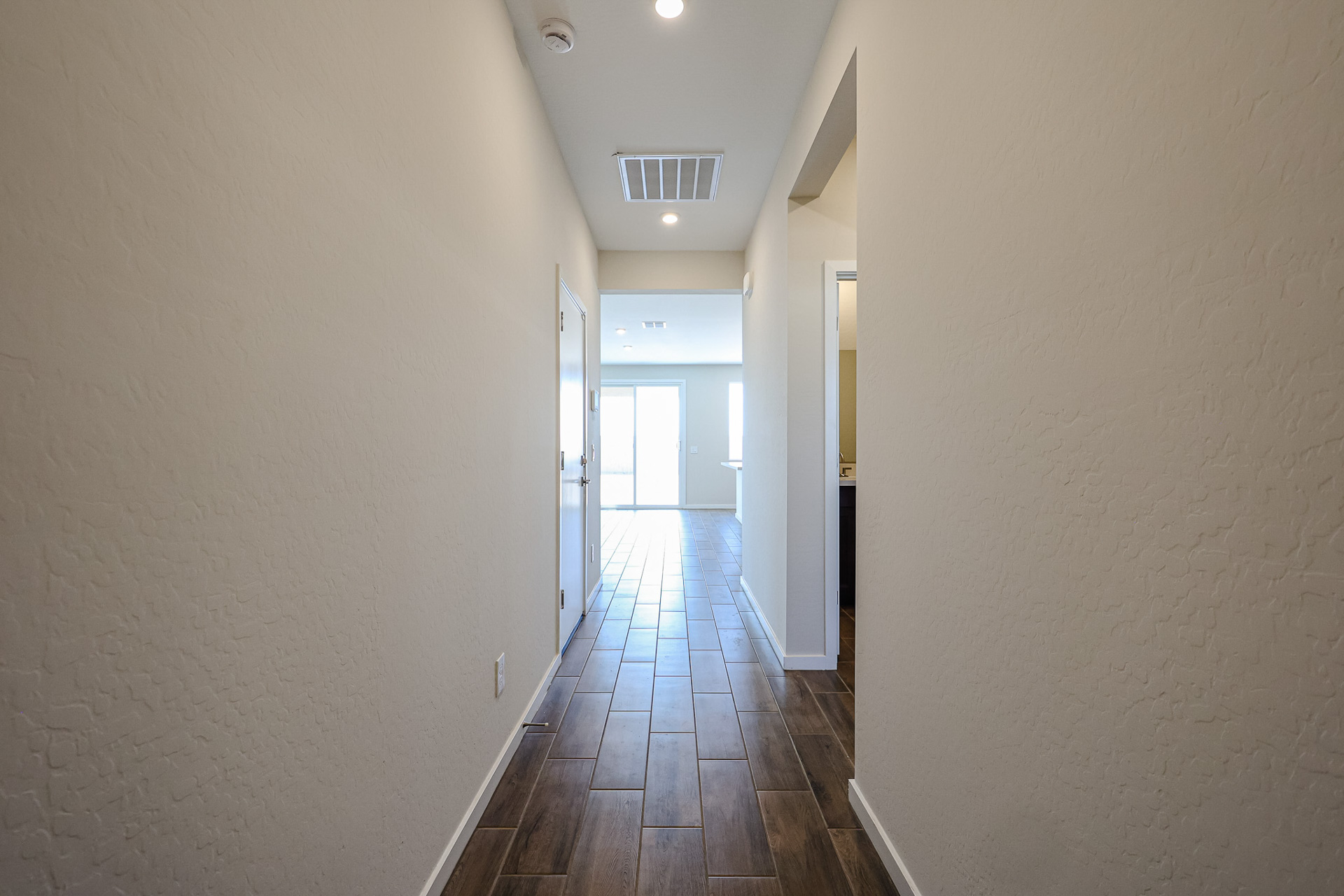 A long hallway with white walls.