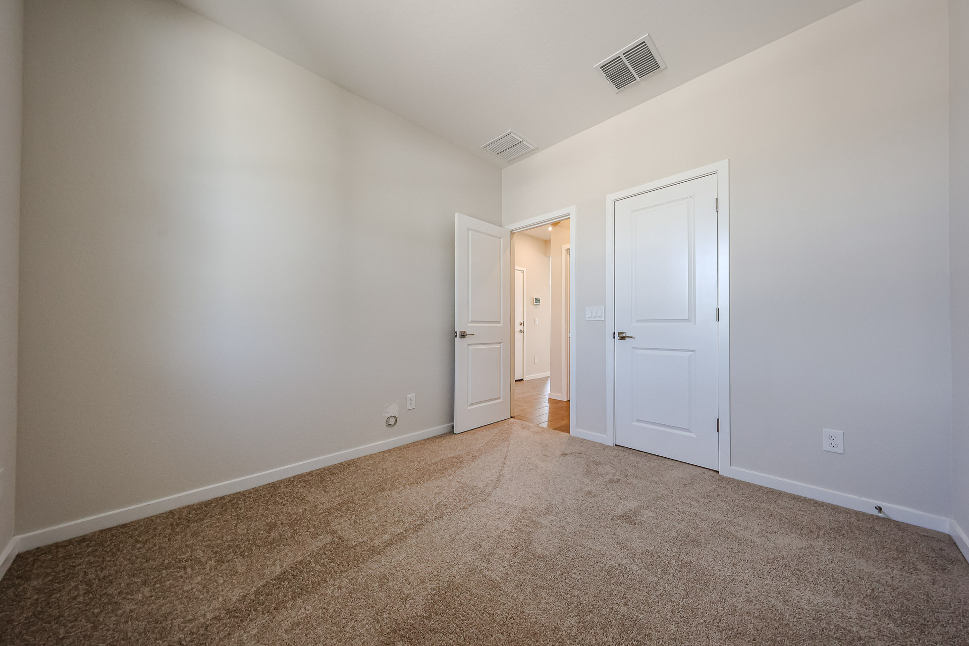 A hallway with white doors.