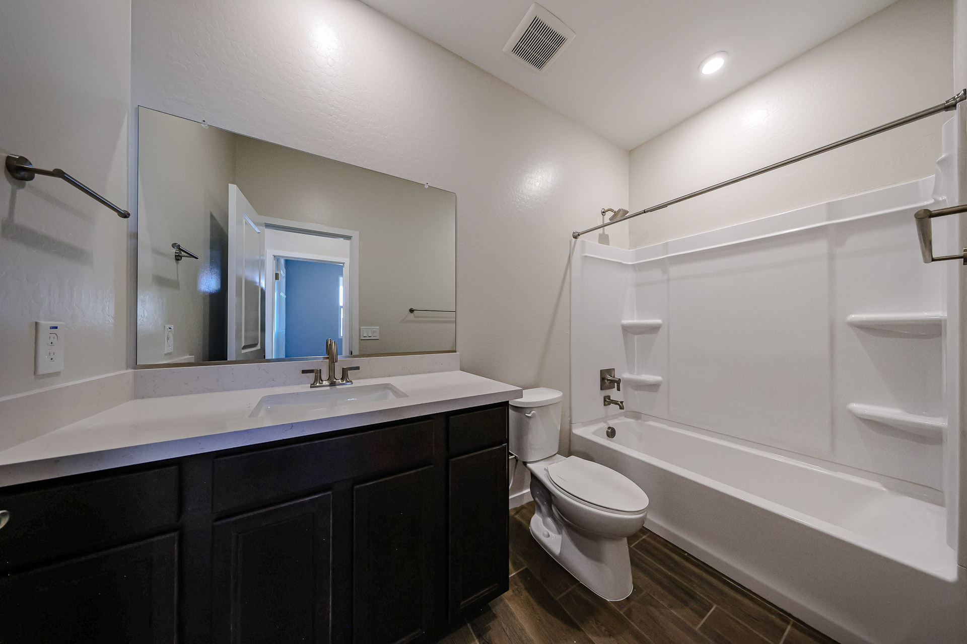 A bathroom with a tub sink and toilet.