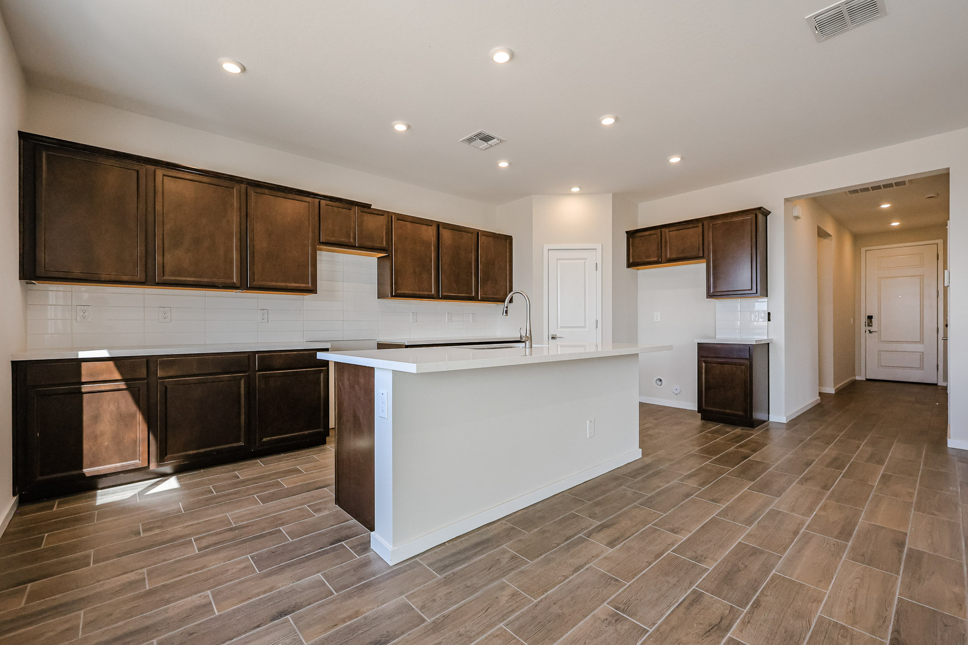 A kitchen with wooden cabinets.