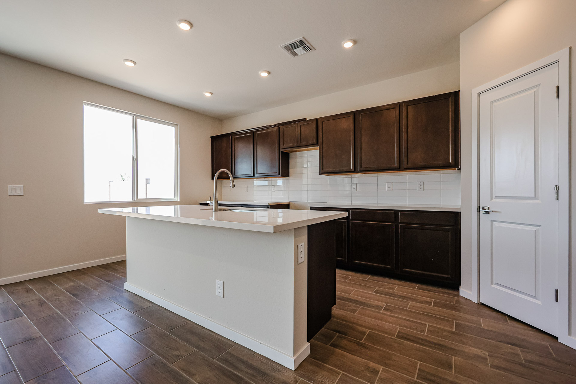 A kitchen with wooden cabinets.