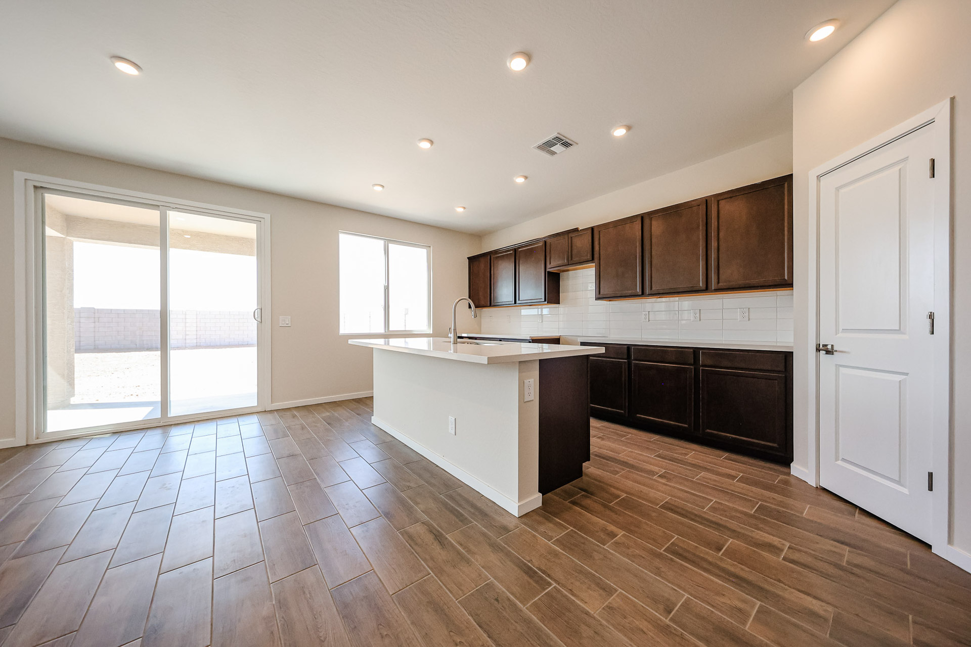 A kitchen with wooden floors.